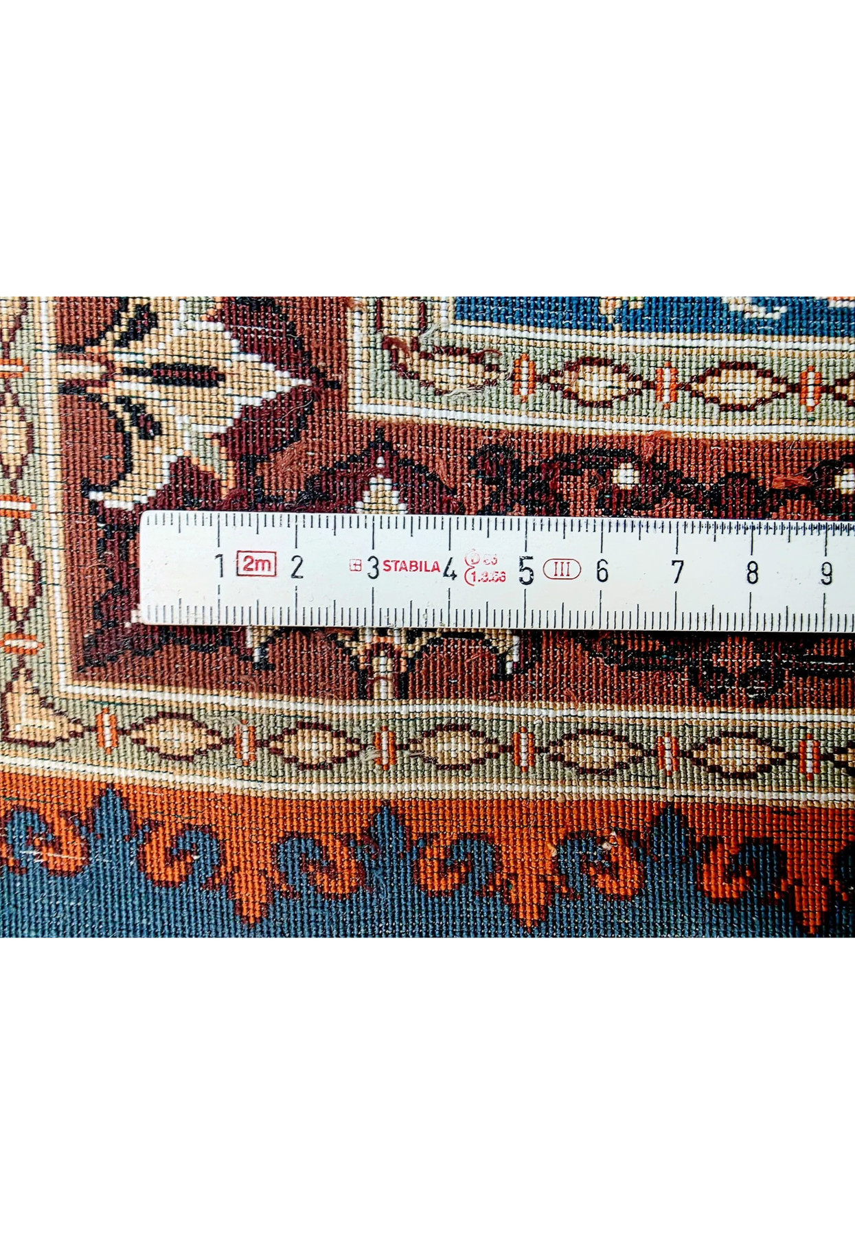 Backside knot density measurement showing approximately 900 KPSI on signed Mohseni Persian Qum pure silk rug
