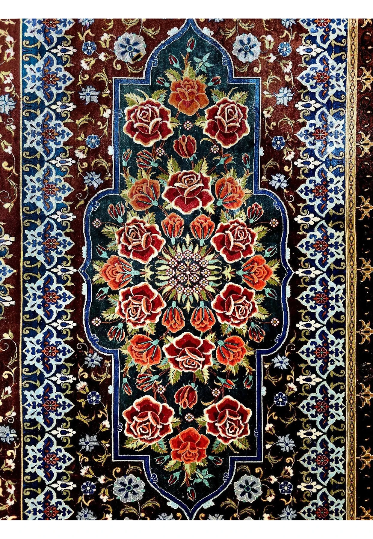 Top cartouche detail of 7x10 signed Mohseni Qum silk rug, lobed Persian arch filled with red roses on teal ground