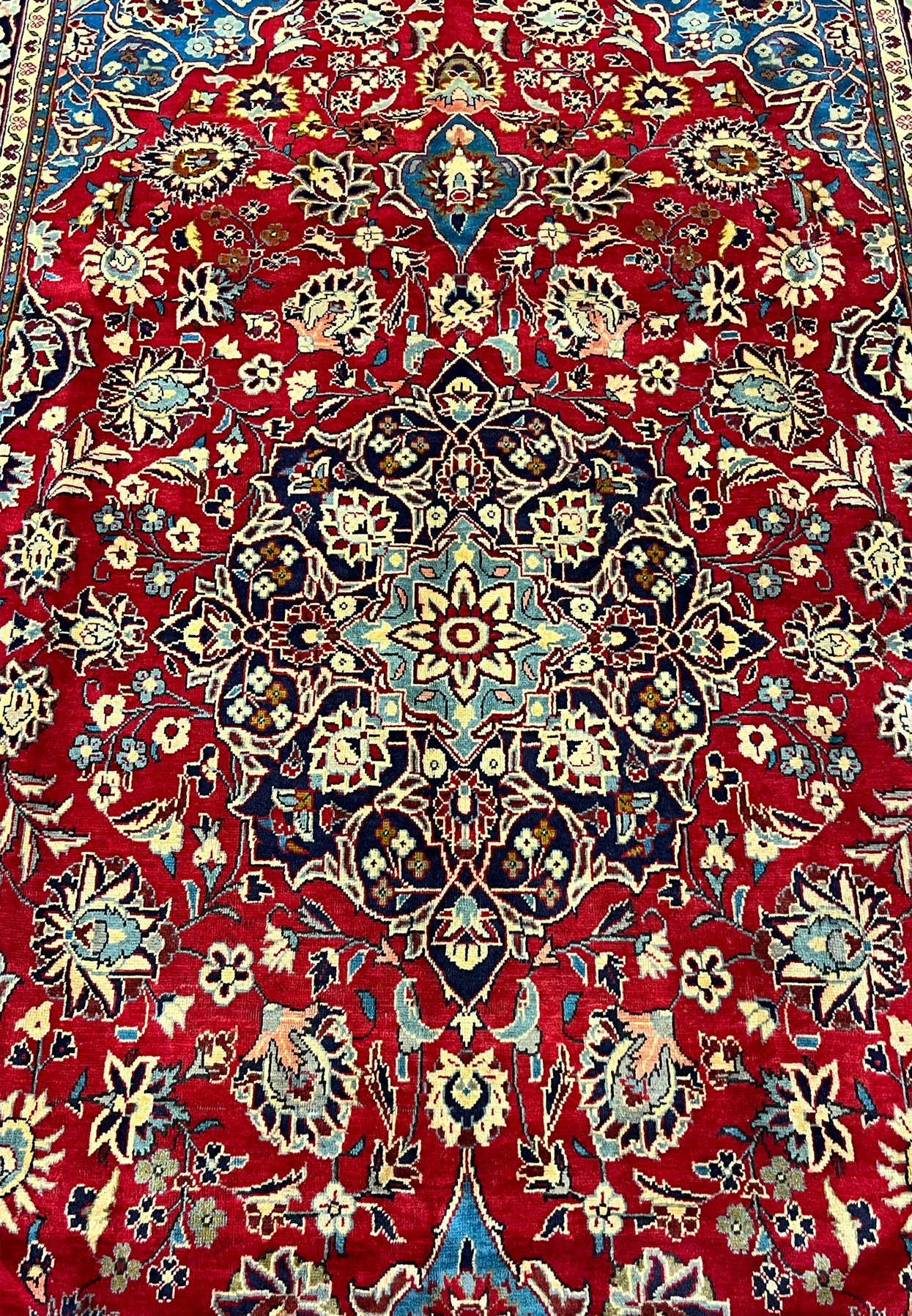 Central layered medallion detail of Persian Najafabad rug, eight point starburst rosette on navy core with ivory cusped lobes
