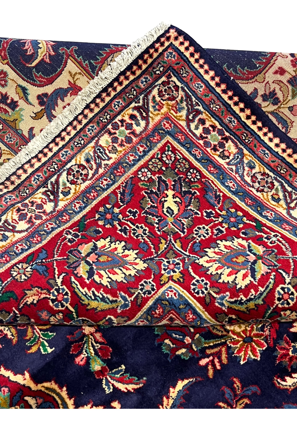 Folded corner of 10x13 Persian Qum kork rug showing clean side cord finish along the fold and intact selvage
