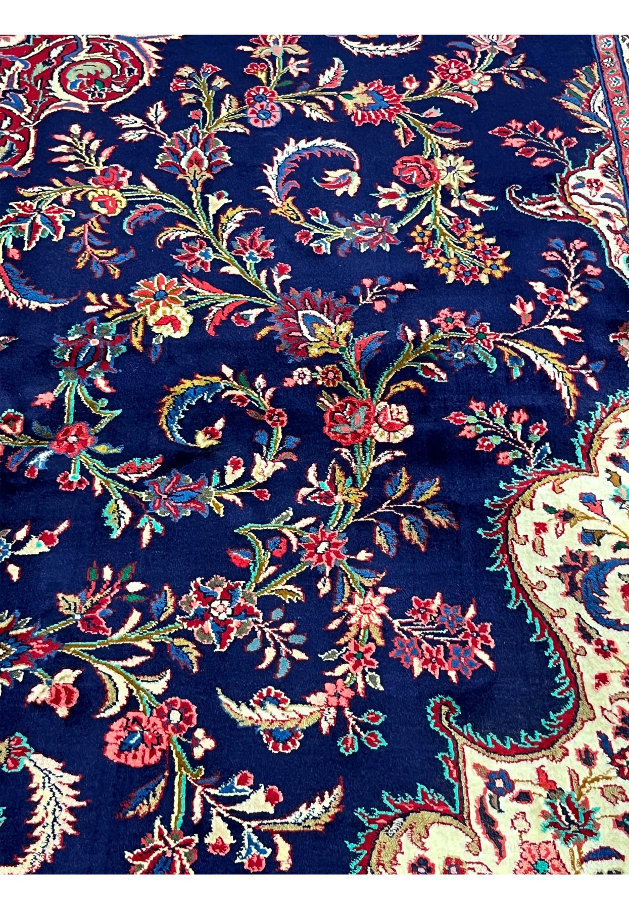 Authentic 280 KPSI Persian Qum kork rug photographed flat, midnight navy ground, ivory spandrels, layered medallion at center