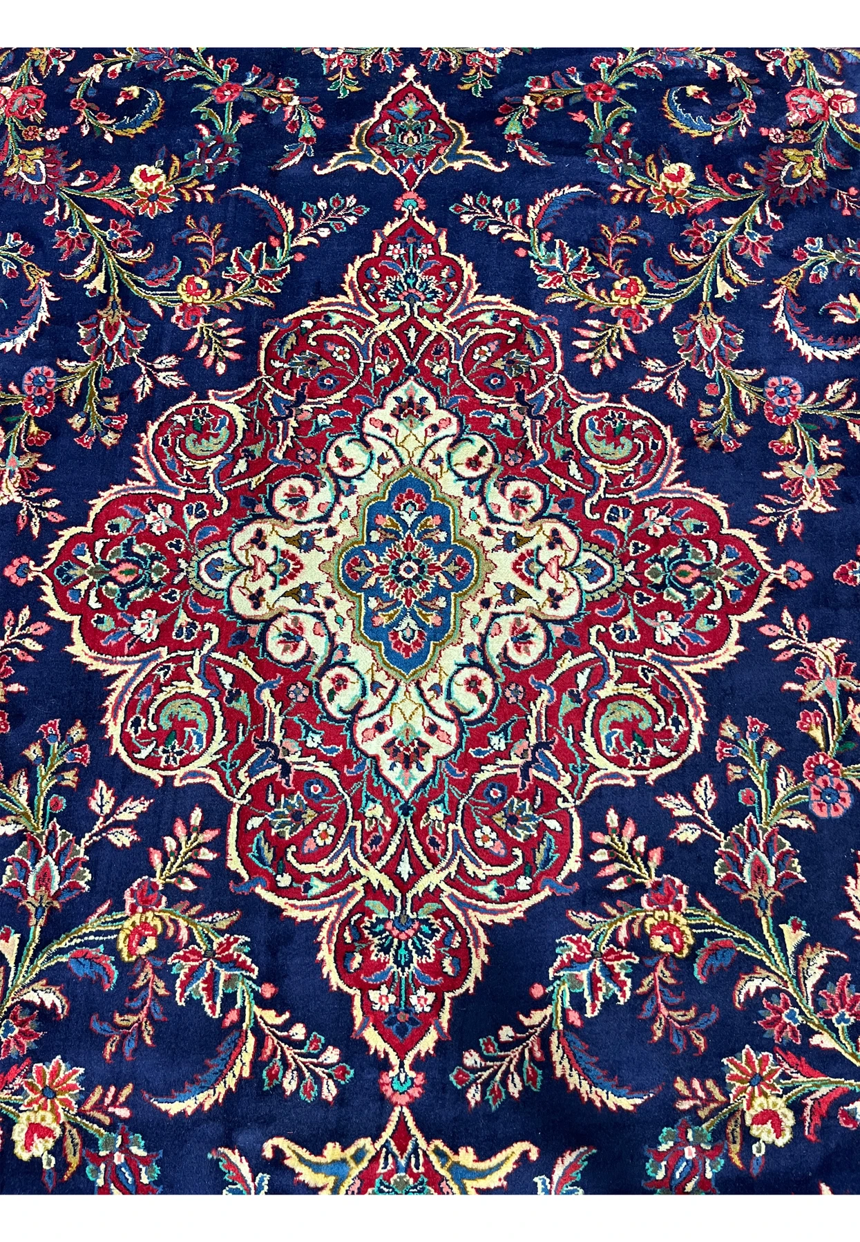 Closeup of inner medallion on Persian Qum kork wool rug, fine kork wool drawing visible at the teal blue and ivory core