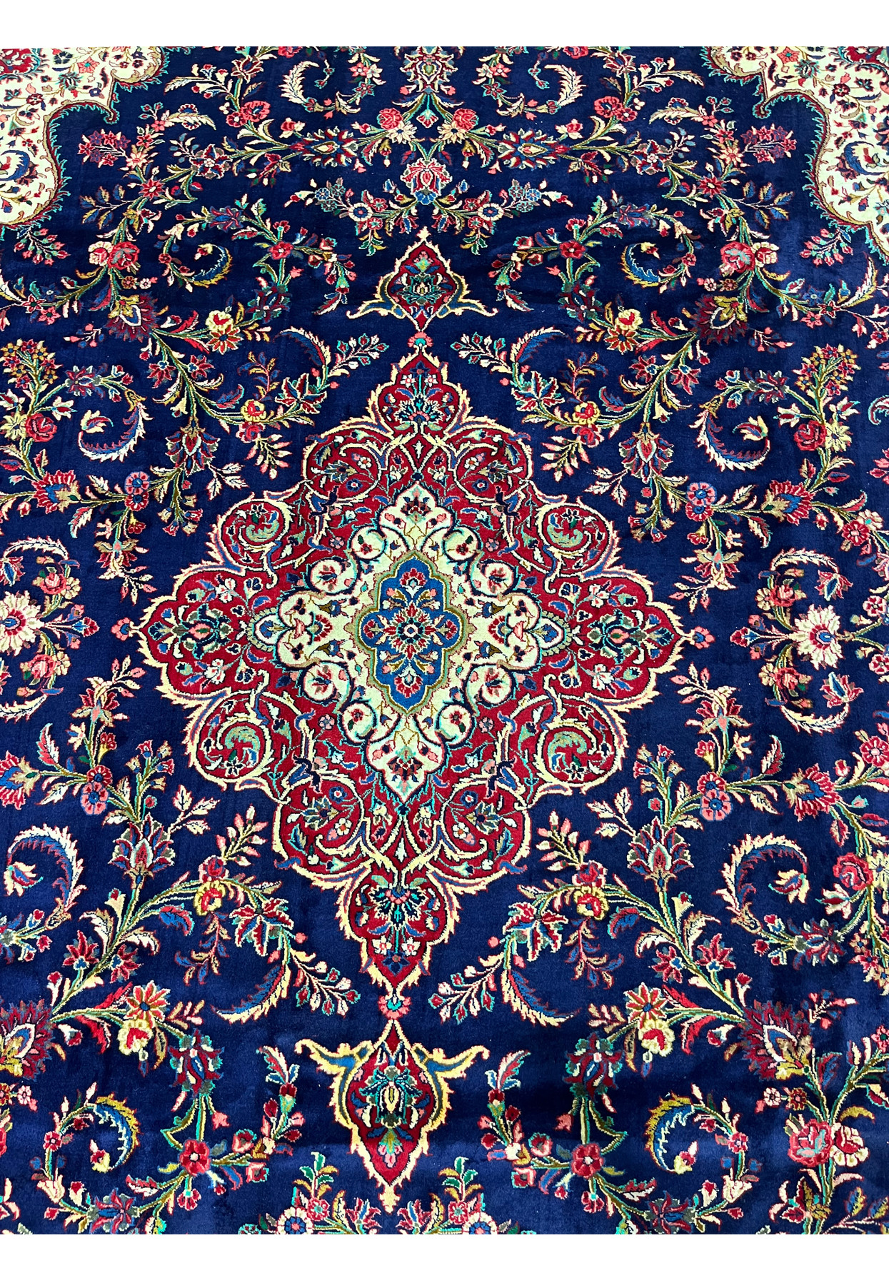 Central layered medallion of Persian Qum kork rug, teal blue starburst core surrounded by ivory cartouche and crimson palmette tiers