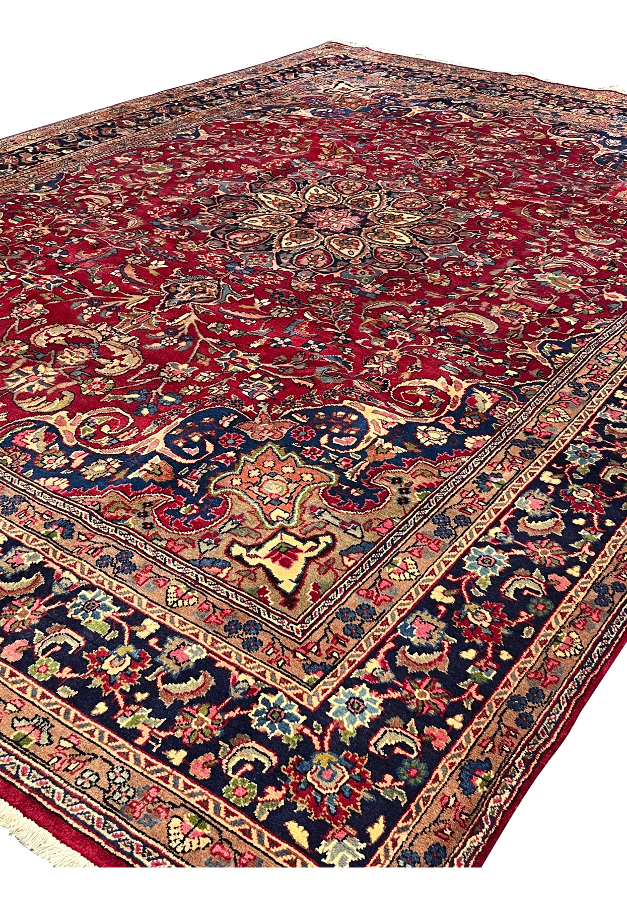 Angled view of authentic Persian Mashad, allover floral field with star medallion, hand-knotted wool, for living room