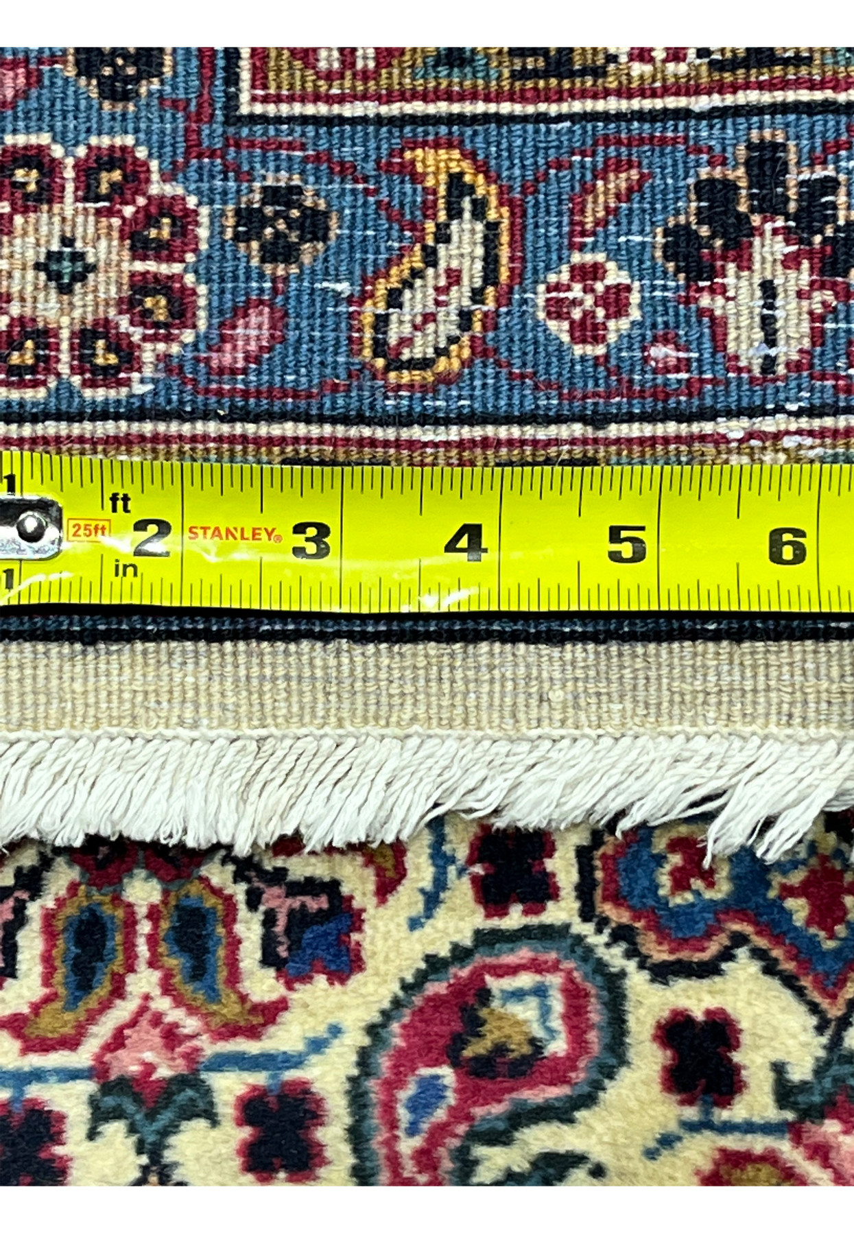 Backside knot density measured on fine Persian Mashad, ruler showing very tight knot count, approximately 400 KPSI