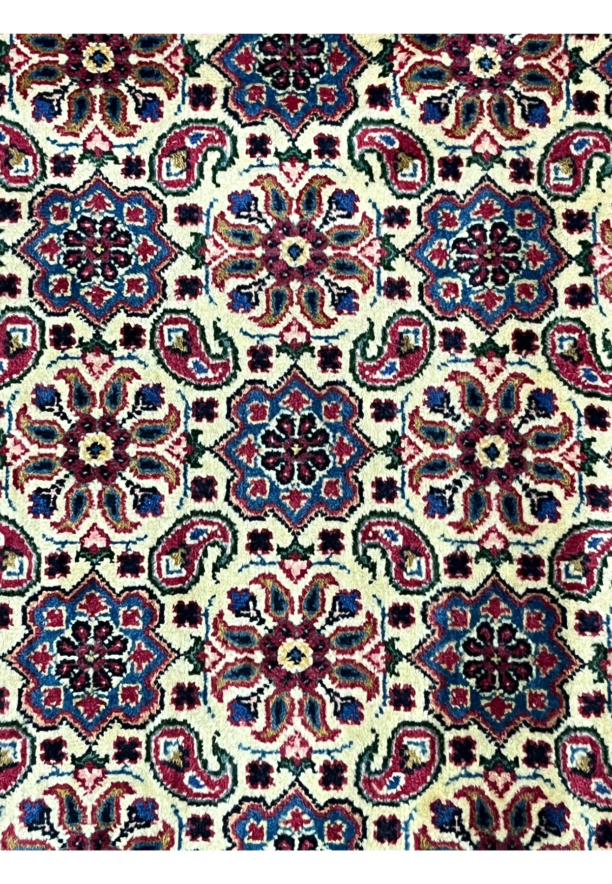Pattern close-up of Persian Mashad, eight-point rosettes and curling paisleys in diamond cells, fine workshop weaving