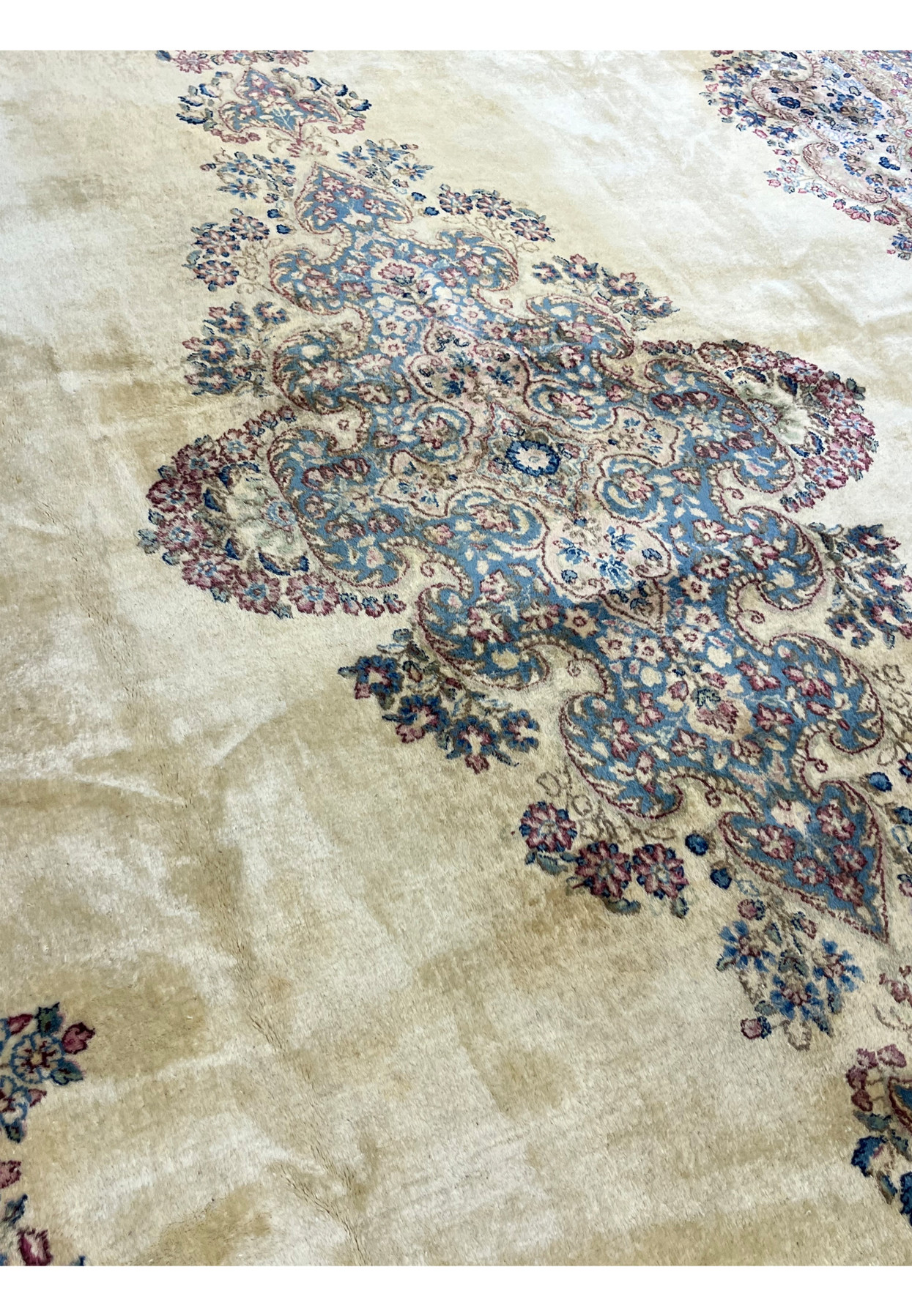 Medallion and ivory field close-up of fine Persian Kerman, sky blue cartouche with sage green and rose floral detail