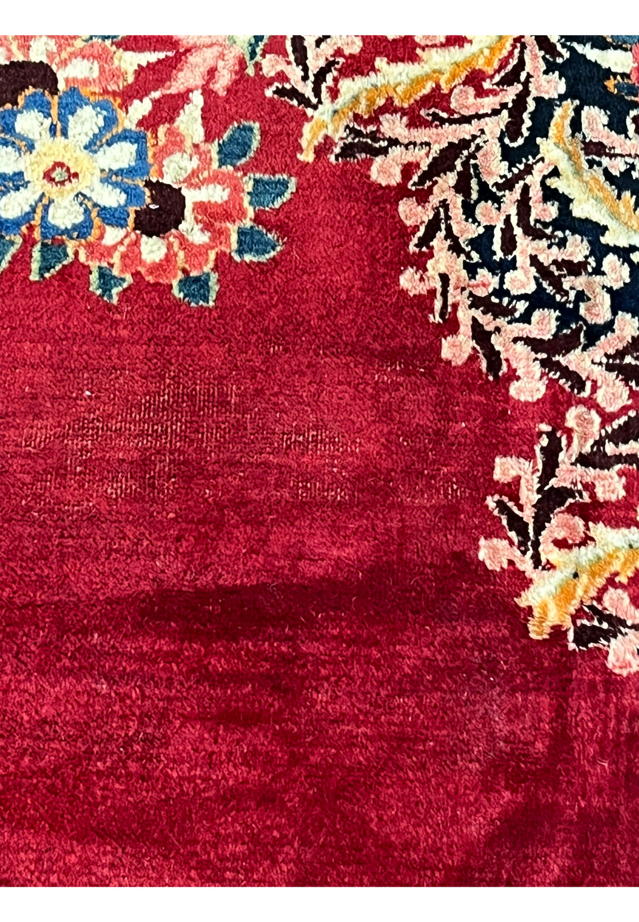 Field of antique Persian Moud showing natural abrash, soft horizontal tonal banding in deep red ground, hallmark of hand dyed wool