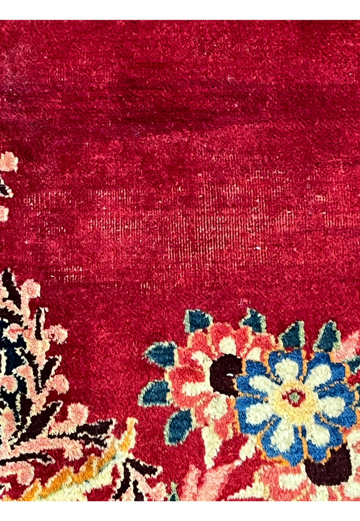 Abrash close-up on red field of antique Persian Moud rug, natural dye lot variation, fingerprint of authentic traditional weaving