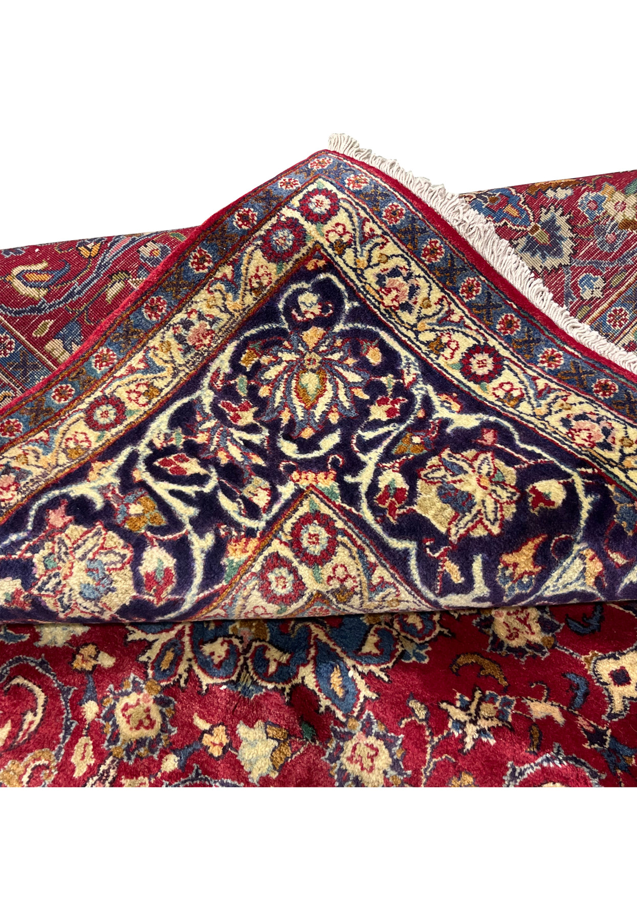 Folded edge of Persian Isfahan rug, dense fine knotting visible on reverse, authentic handmade wool on cotton for formal traditional interior