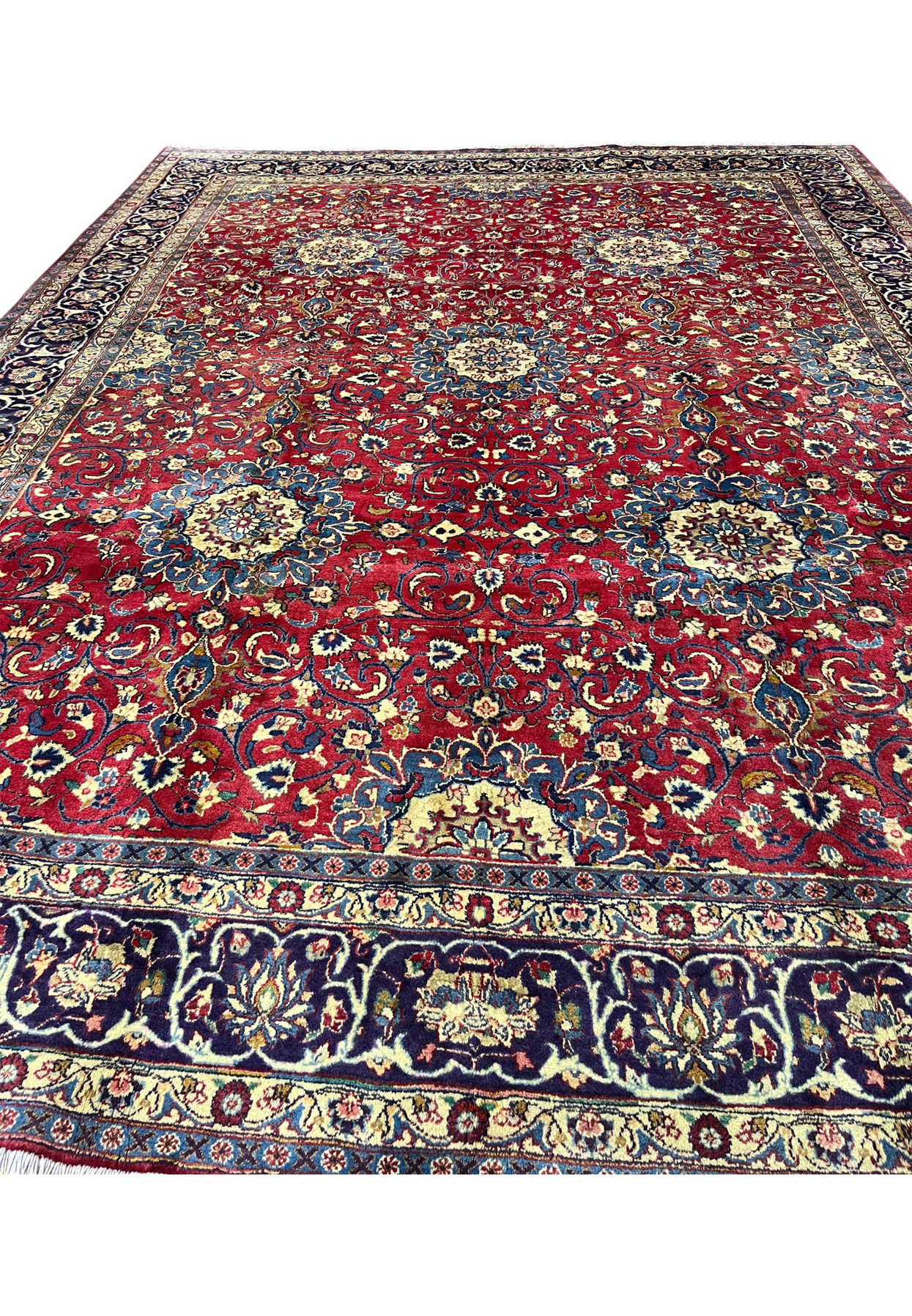 Deep red Persian Isfahan rug top view, ivory rosettes and scrolling vines on ruby ground, authentic hand-knotted workshop weave