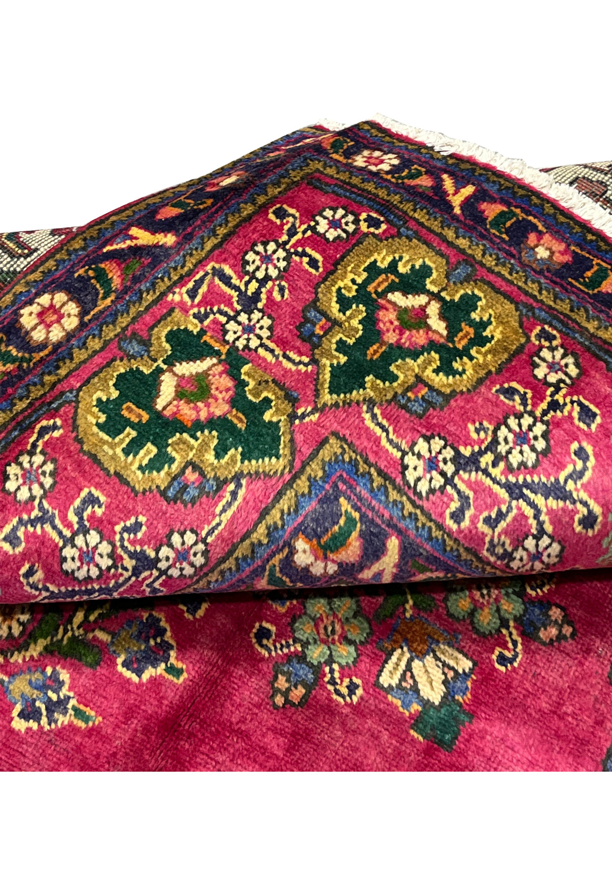 Folded edge of Persian Kerman rug, fine knotting visible on reverse, authentic handmade wool on cotton for formal traditional interior