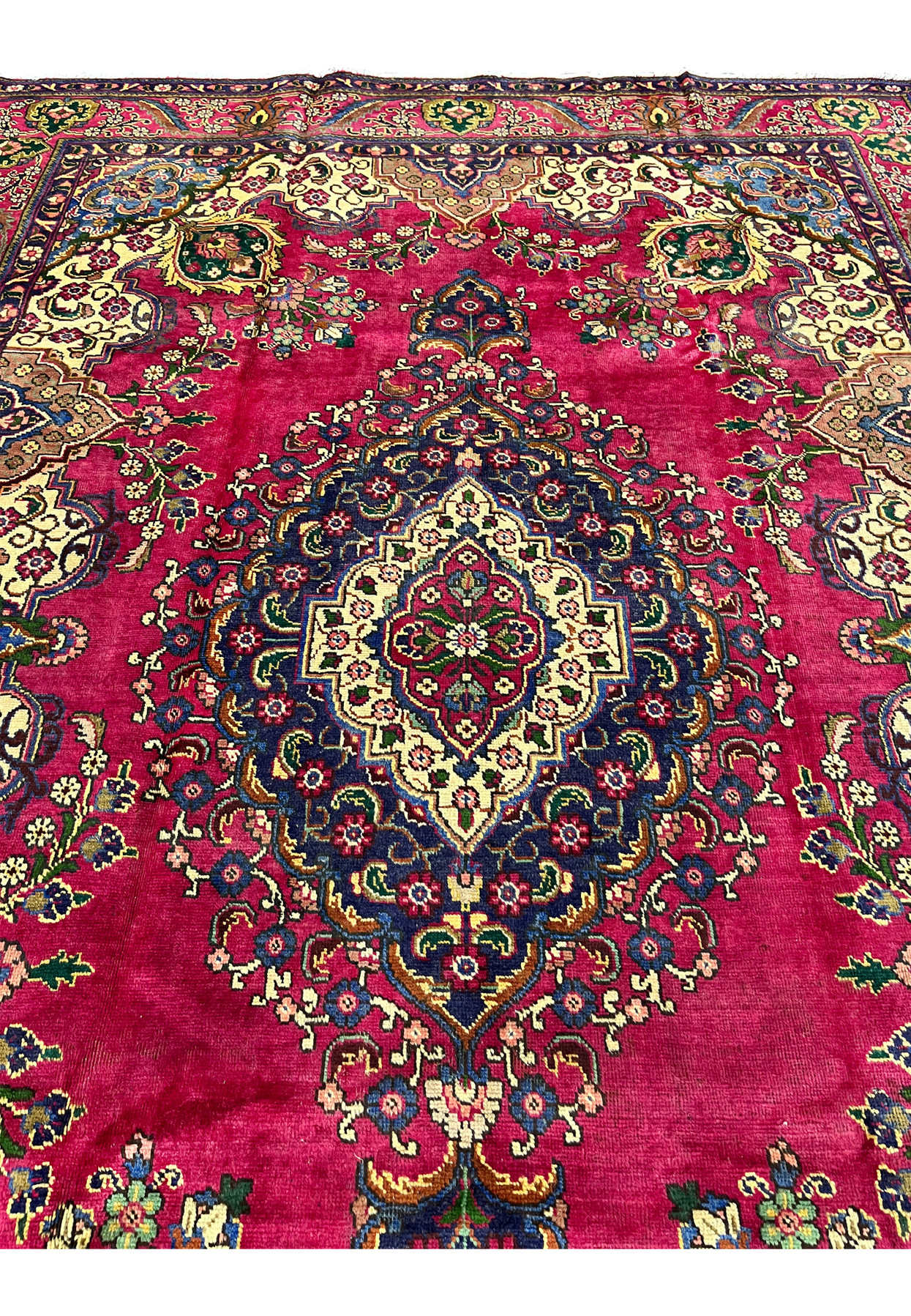 Midfield detail Persian Kerman rug, navy diamond medallion and ivory cartouche on saturated magenta ground, hand-knotted wool