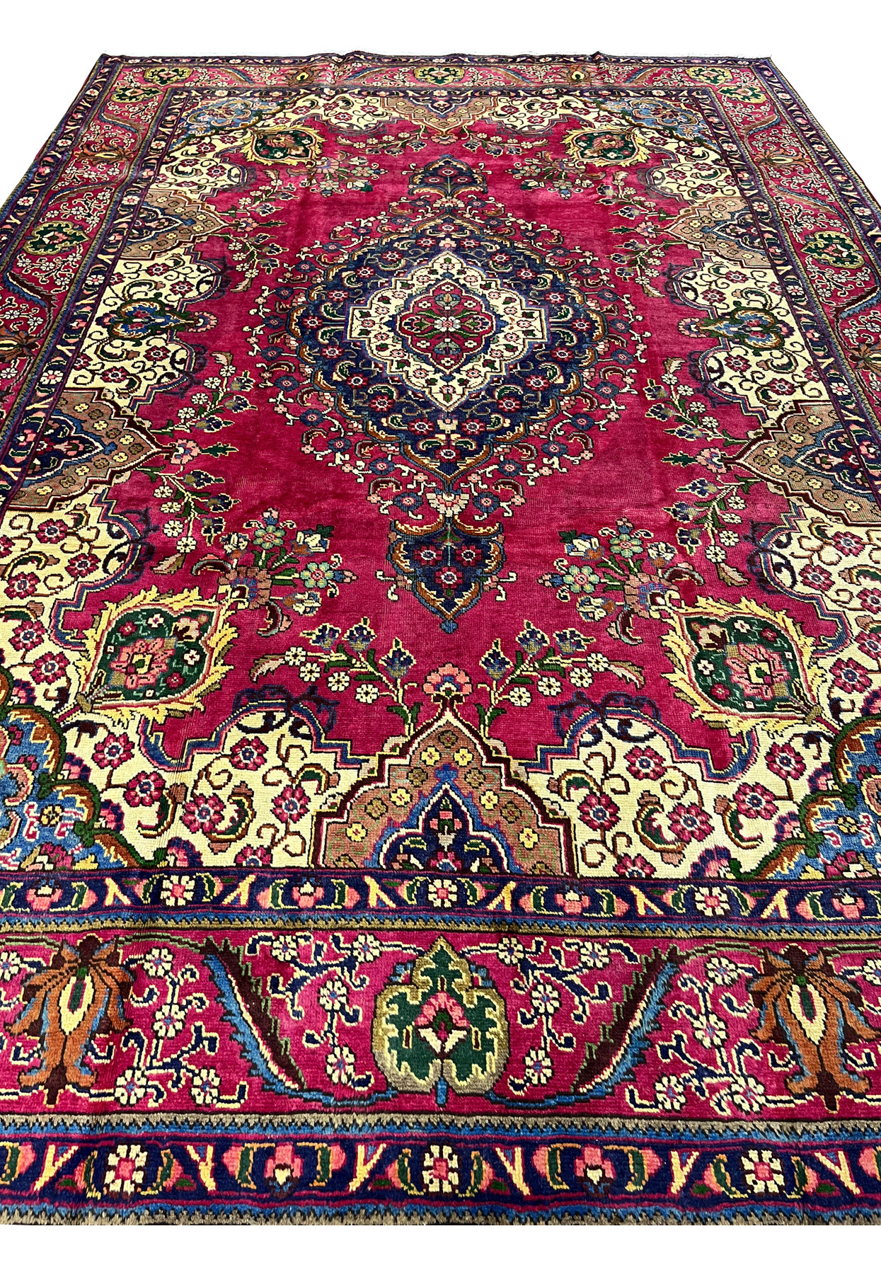 Top view of Persian Kerman rug, classic medallion-and-spandrel layout in magenta and navy, fine handmade wool for formal living room