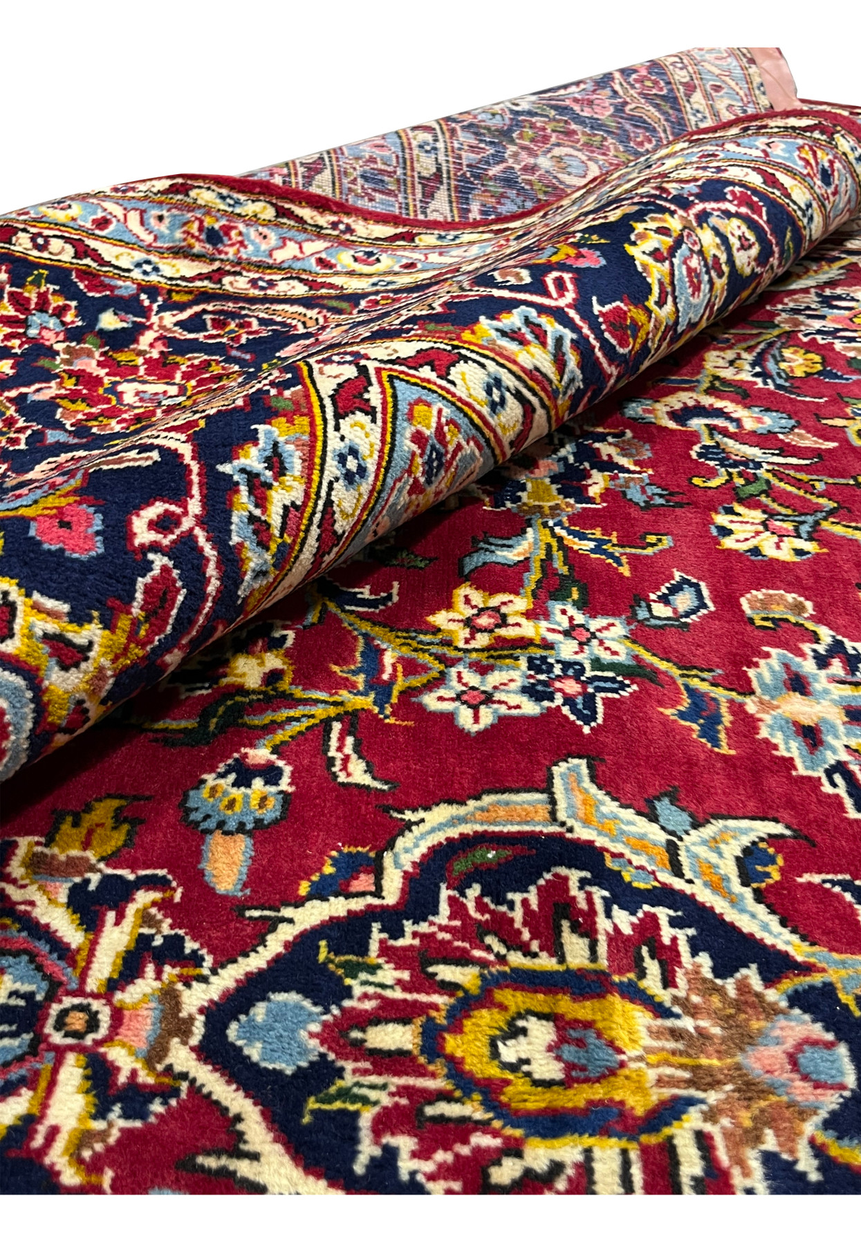 Rolled view Persian Kashan rug showing pile depth and back, 180 to 220 KPSI hand-knotted wool on cotton, never used