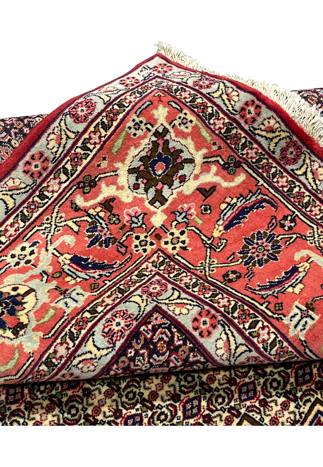 Folded edge of Persian Senneh rug, fine knotting visible on reverse, authentic Kurdish handmade wool on cotton for formal interior
