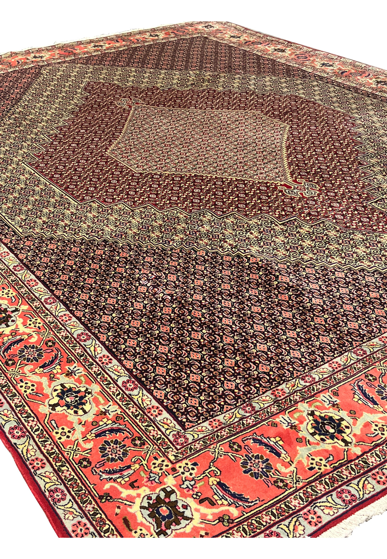 Angled view of 10x13 Persian Senneh rug, stepped diamond medallion with fine herati field, hand-knotted for large dining room