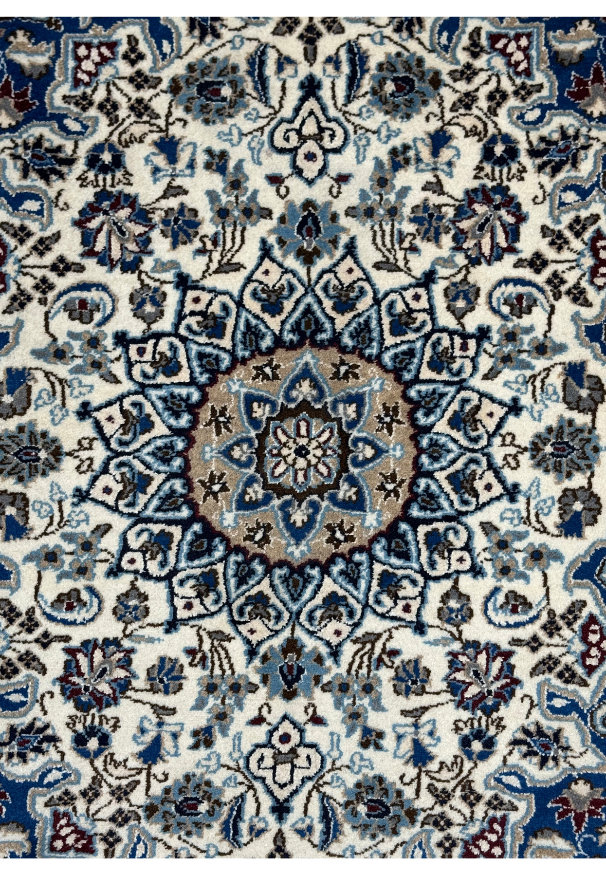 Camel center medallion close-up of authentic Persian Nain rug, sky blue and navy stepped cartouches on ivory ground