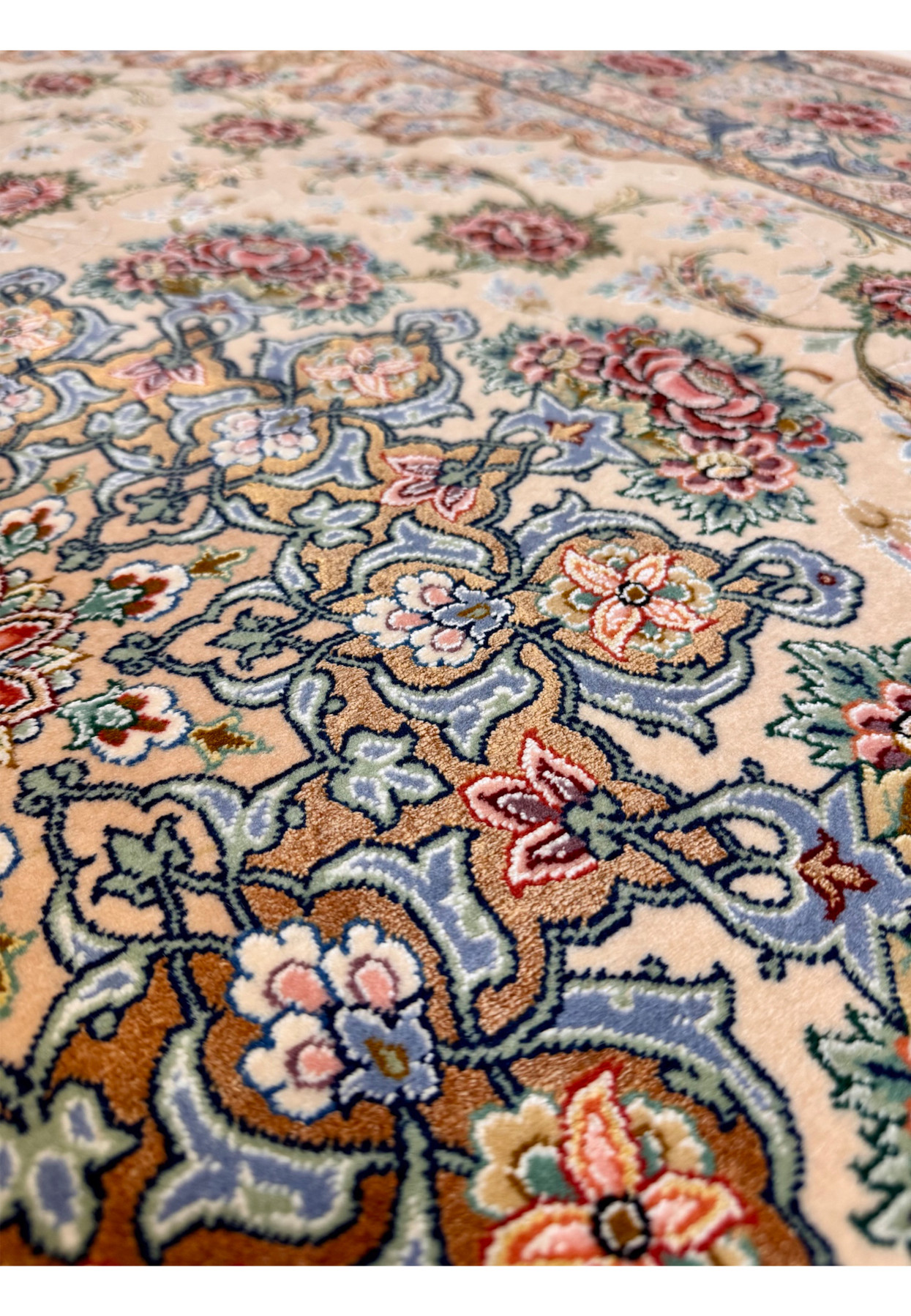 Silk highlights close-up on Master Habib Isfahan rug, raised silk floral work catching light beside kork wool