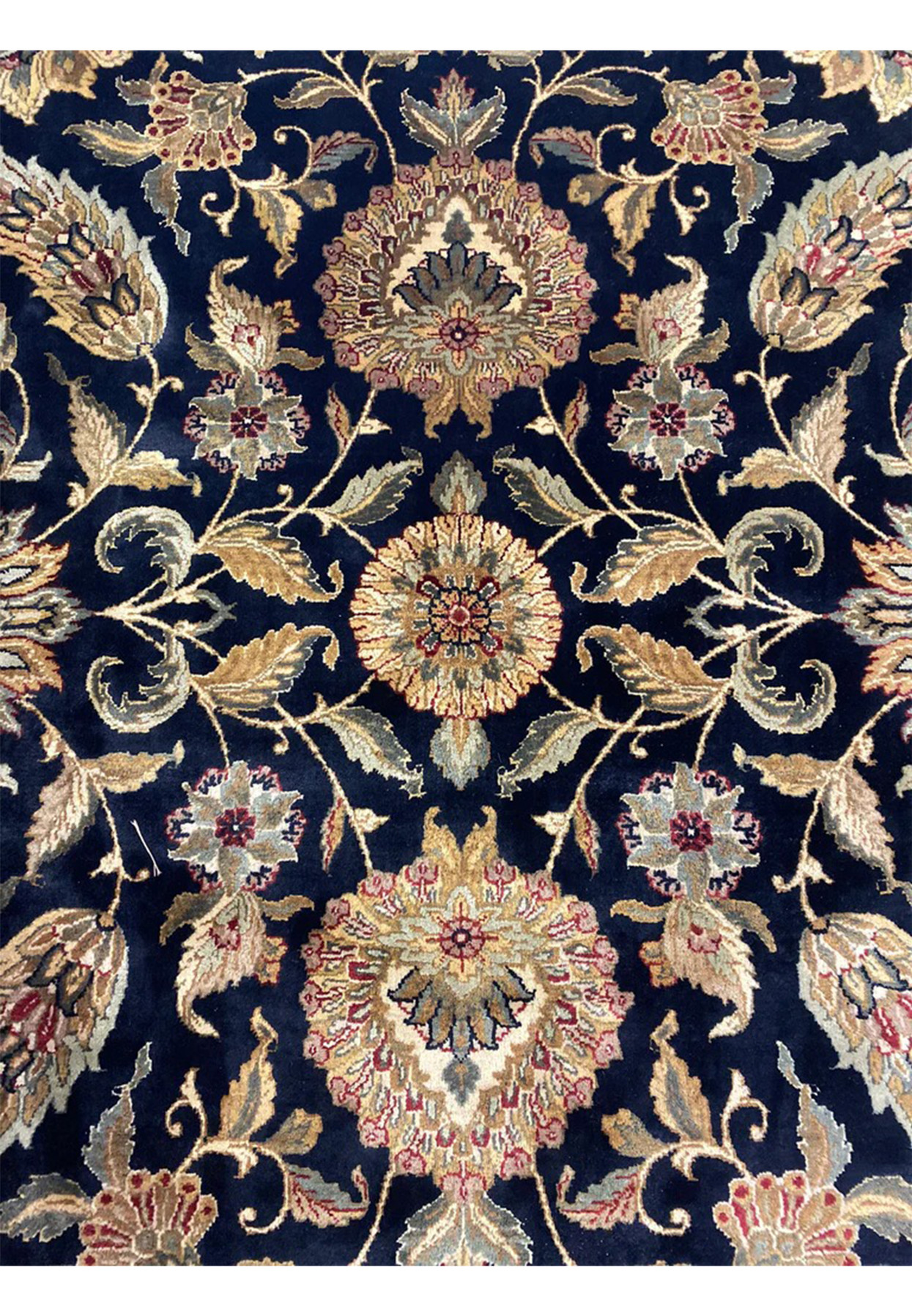 Allover floral close-up of Jaipur rug, midnight blue ground with mirrored palmettes paisleys and rosettes in antique gold