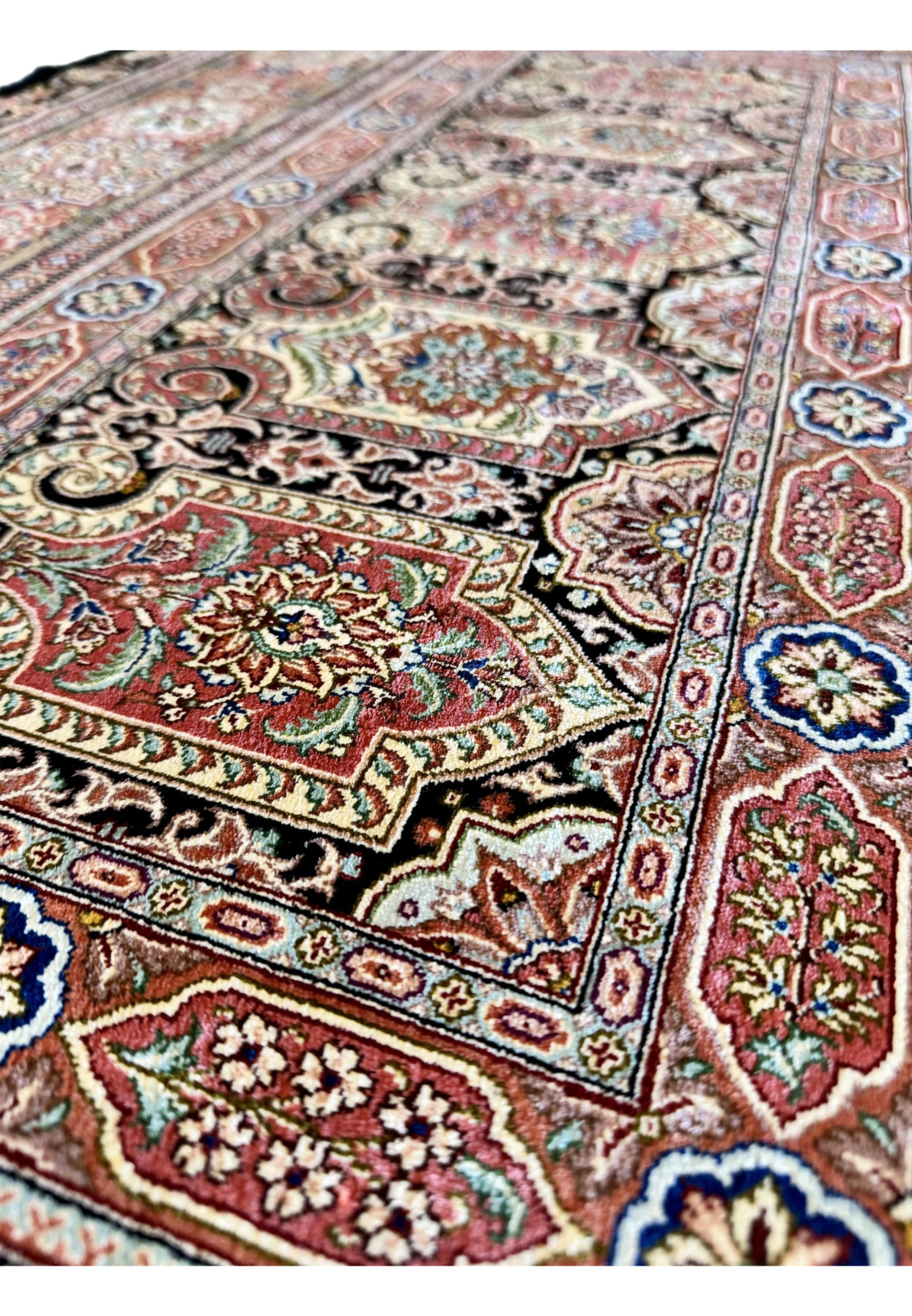Pattern detail of master signed Qum silk rug, densely drawn floral panels in terracotta salmon and royal blue