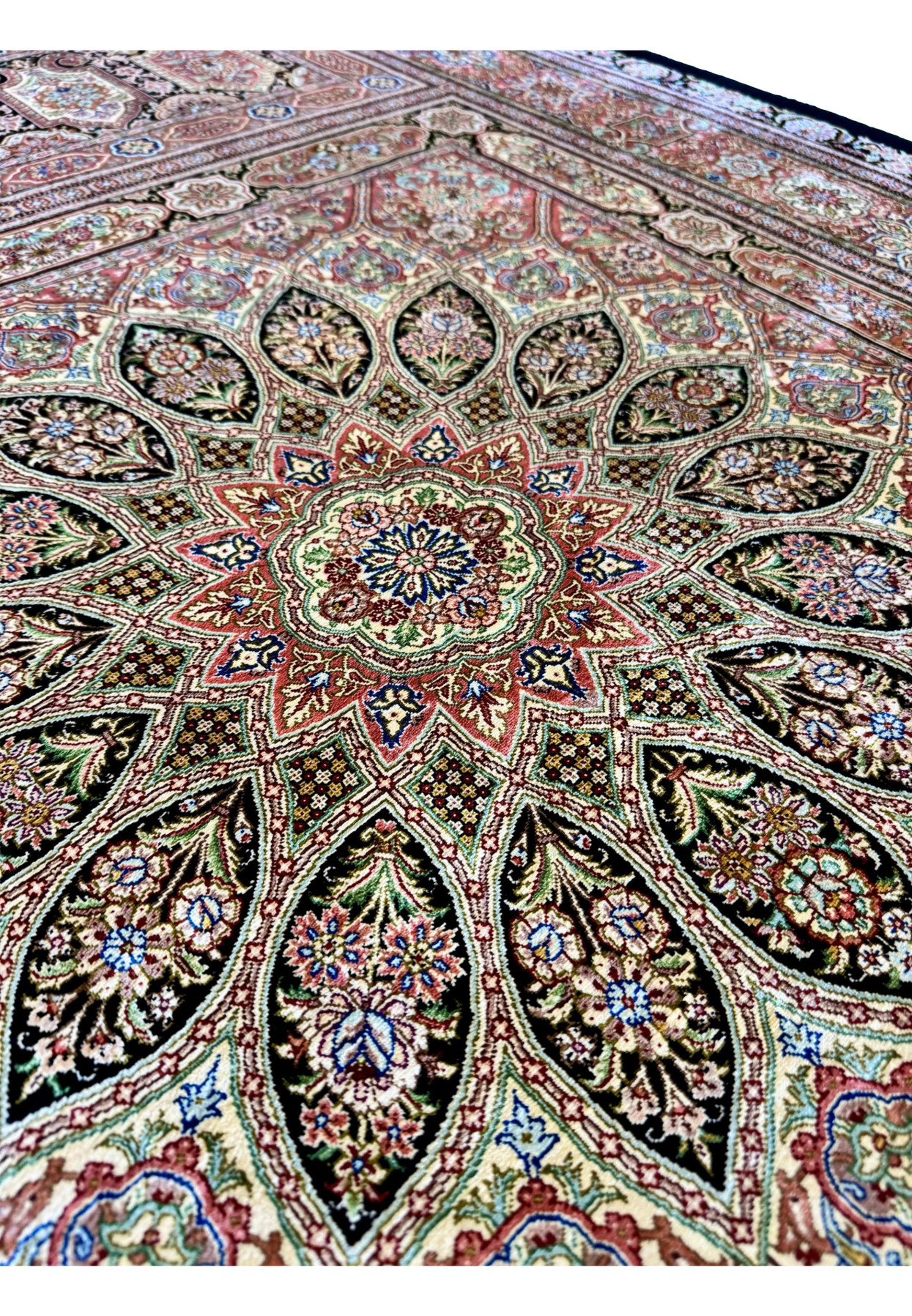 Dome medallion detail of signed Qum silk rug, radiating floral compartments around a central rosette