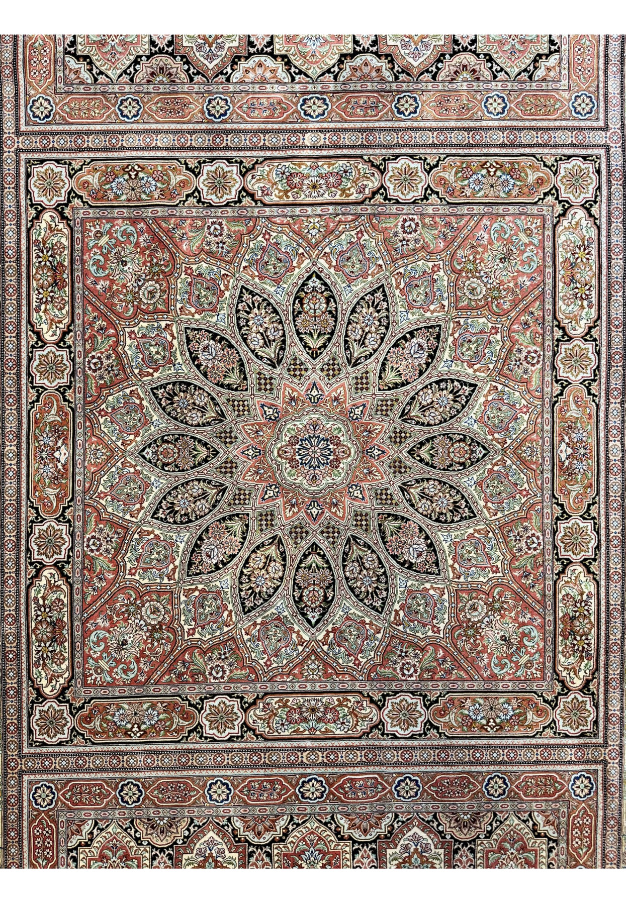 Dome medallion close-up of Persian Qum silk rug, radiating starburst of floral compartments in jewel tones