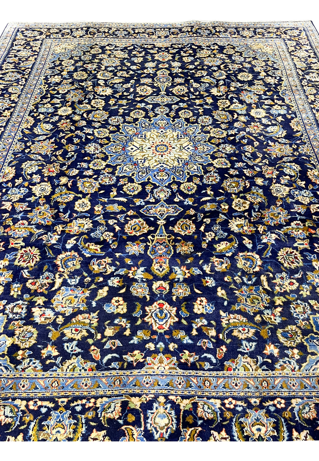 Navy Persian Kashan rug midfield showing dense Shah Abbas palmettes around the central star medallion