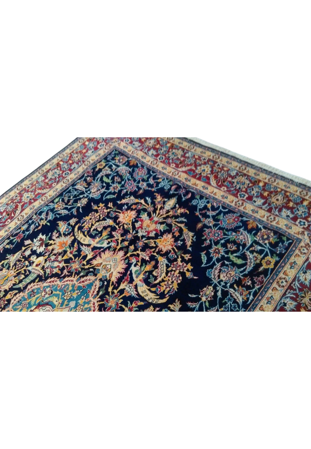 Upper field of Persian Isfahan rug showing scrolling vines, palmettes, and perched birds