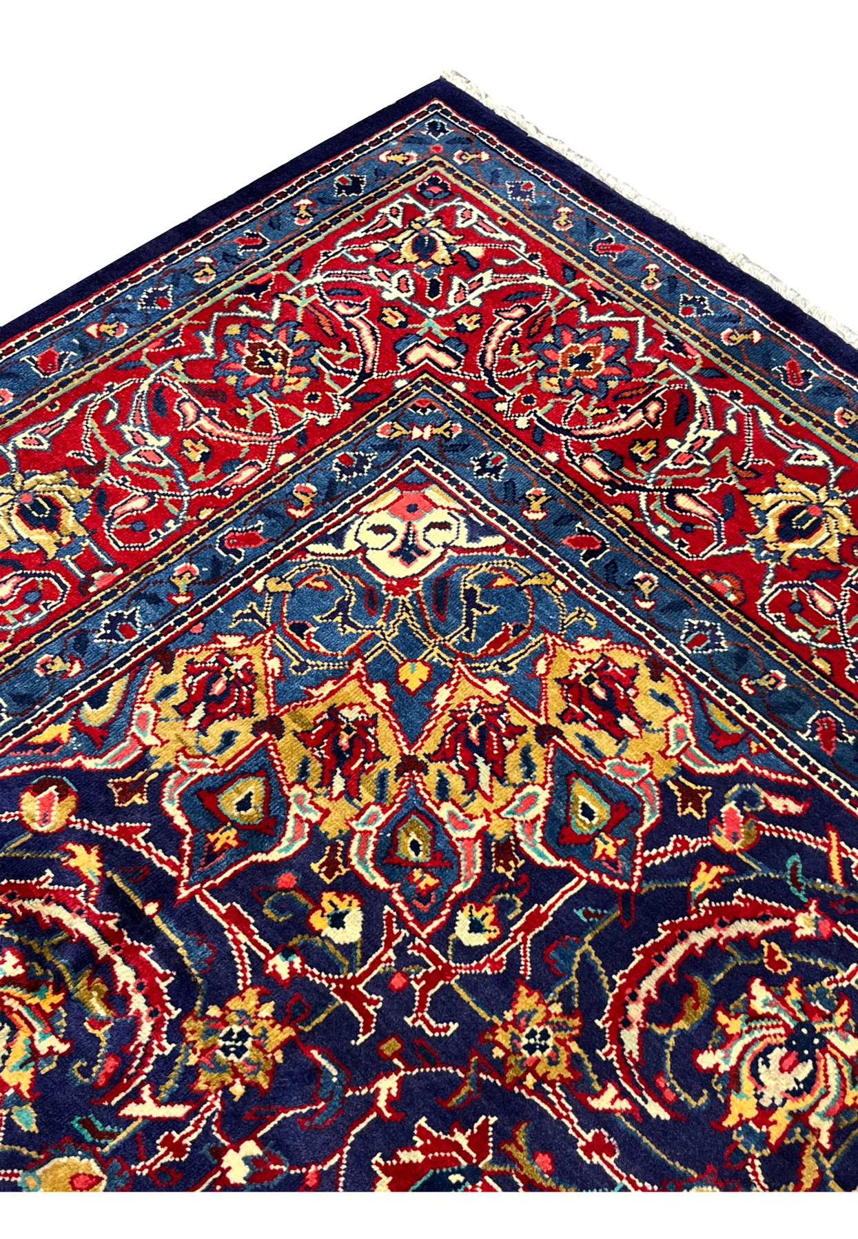 Edge detail of Persian Mahal rug, ivory four-petal flowerheads against deep navy ground