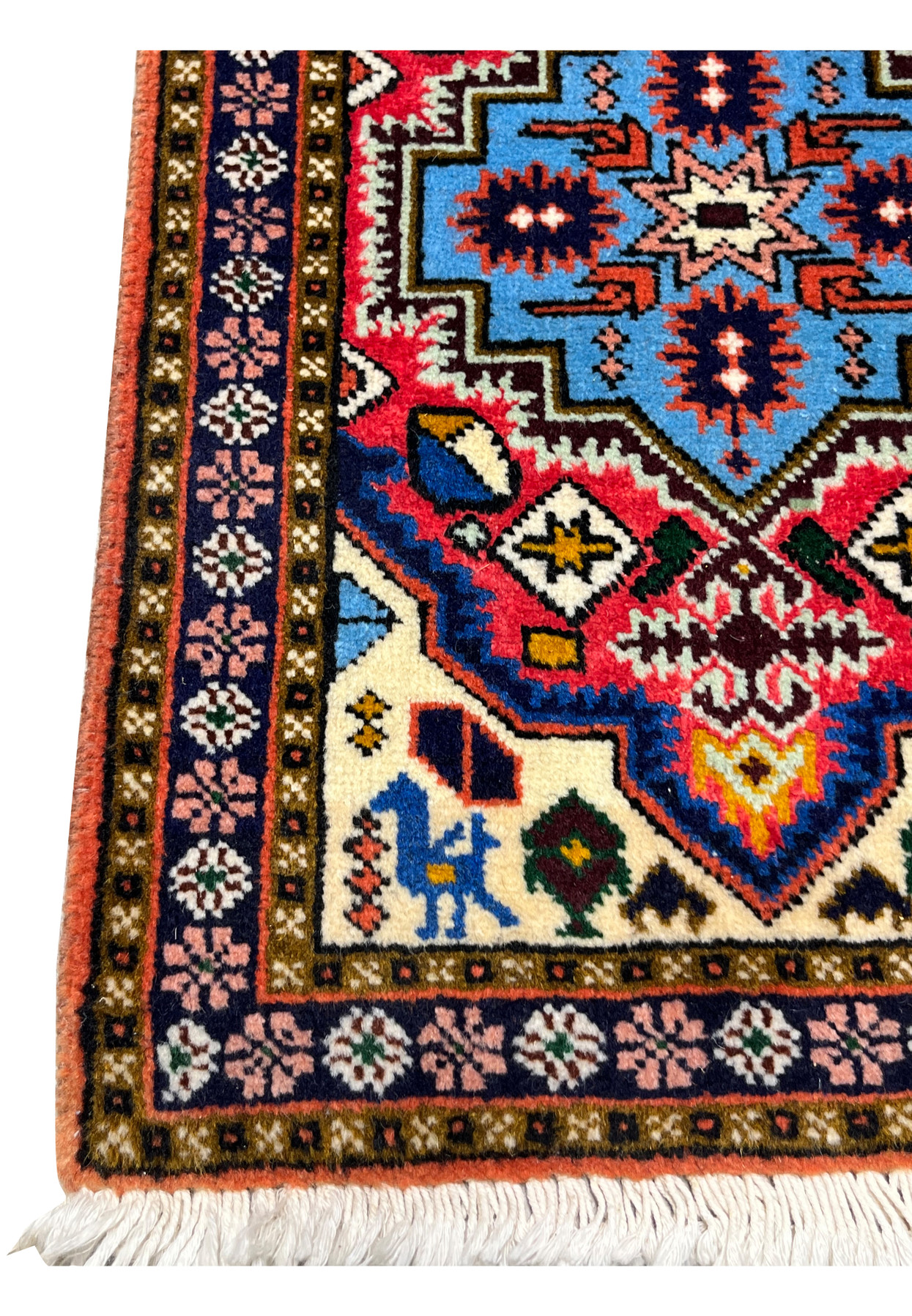 Navy border with pink rosettes and ivory spandrel with horse-and-rider motif, Persian Ardebil baby rug detail