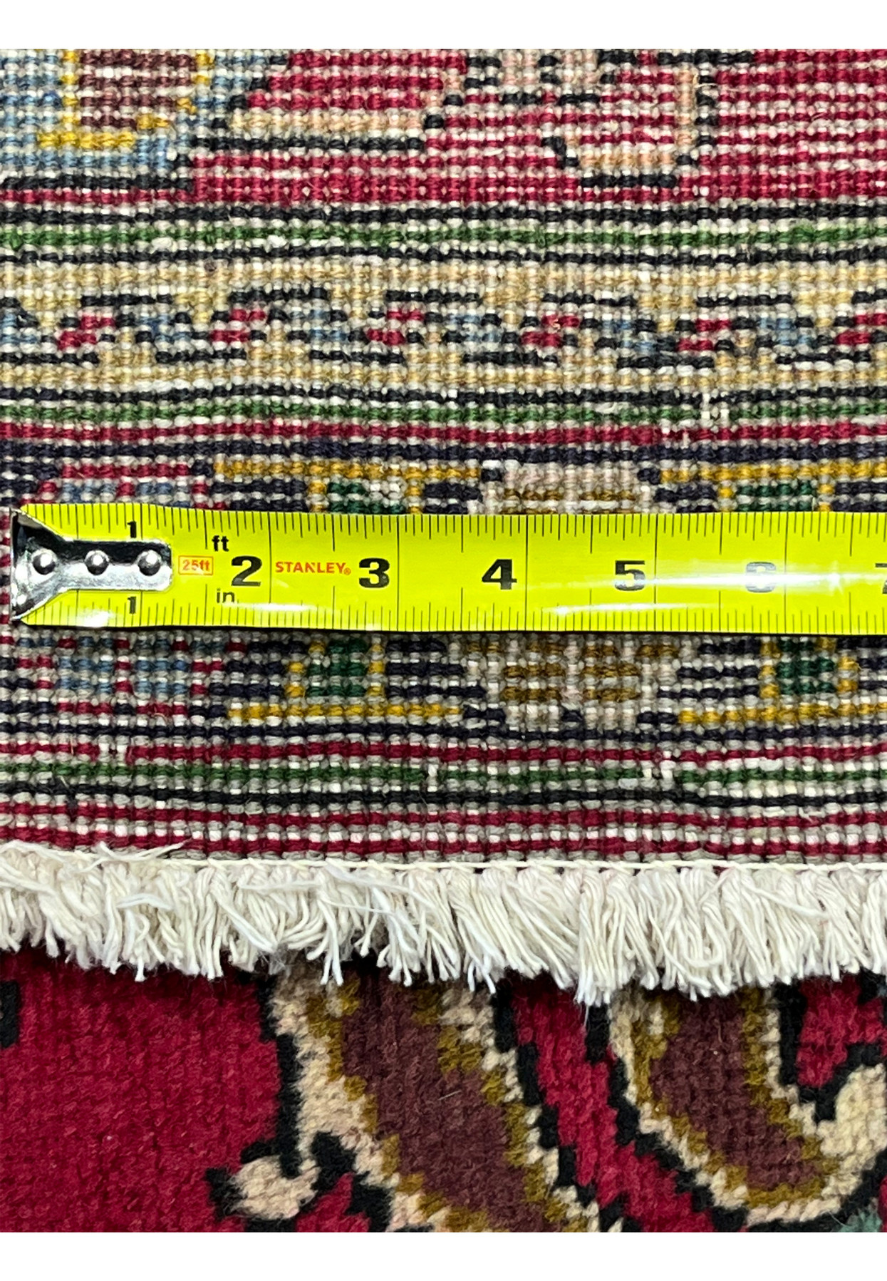 Knot density tape measurement on reverse of Persian Tabriz rug confirming 160 to 180 KPSI hand-knotted weave
