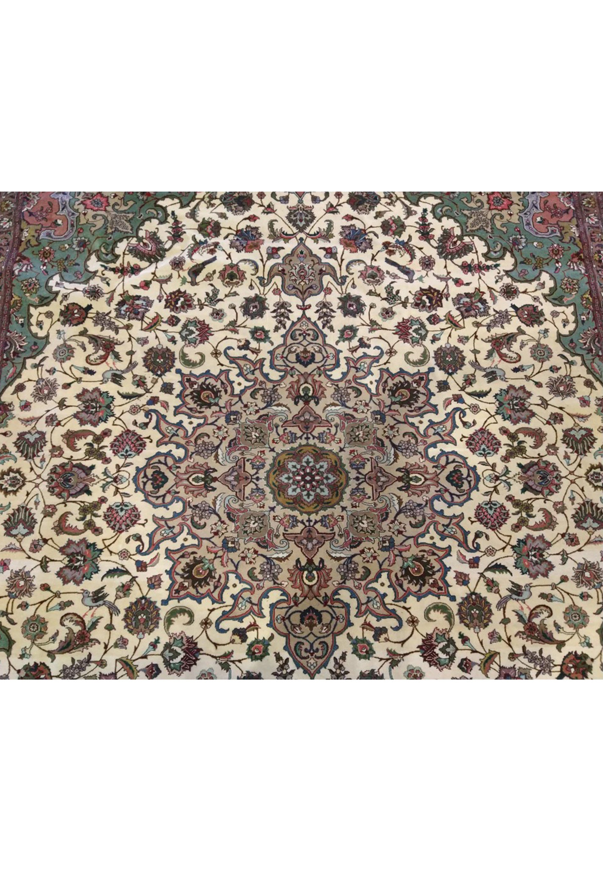 Delicate central rosette medallion of Persian Tabriz 50 raj rug, small floating motif in dense floral field