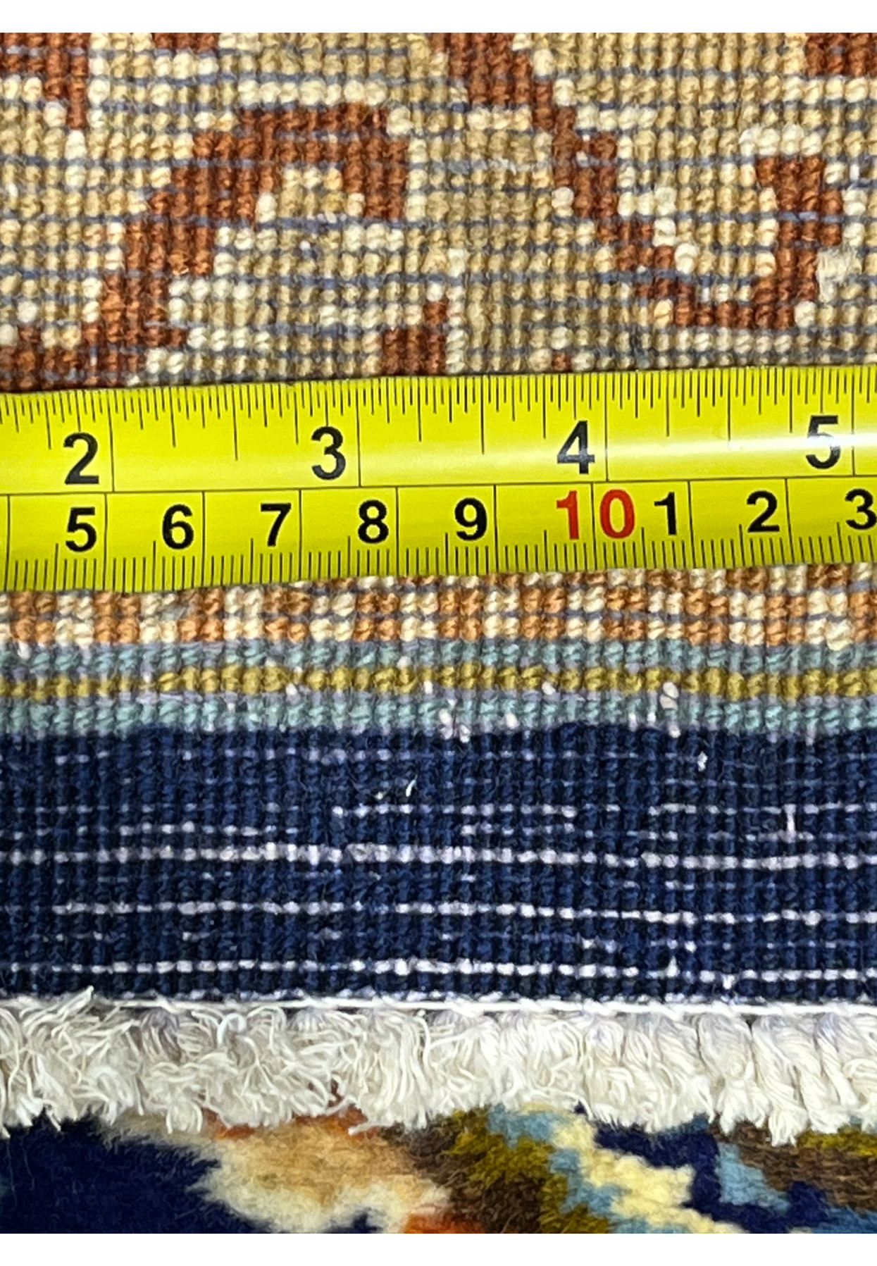 Knot density tape measurement on reverse of Persian Yazd rug confirming 280 to 300 KPSI hand-knotted wool weave