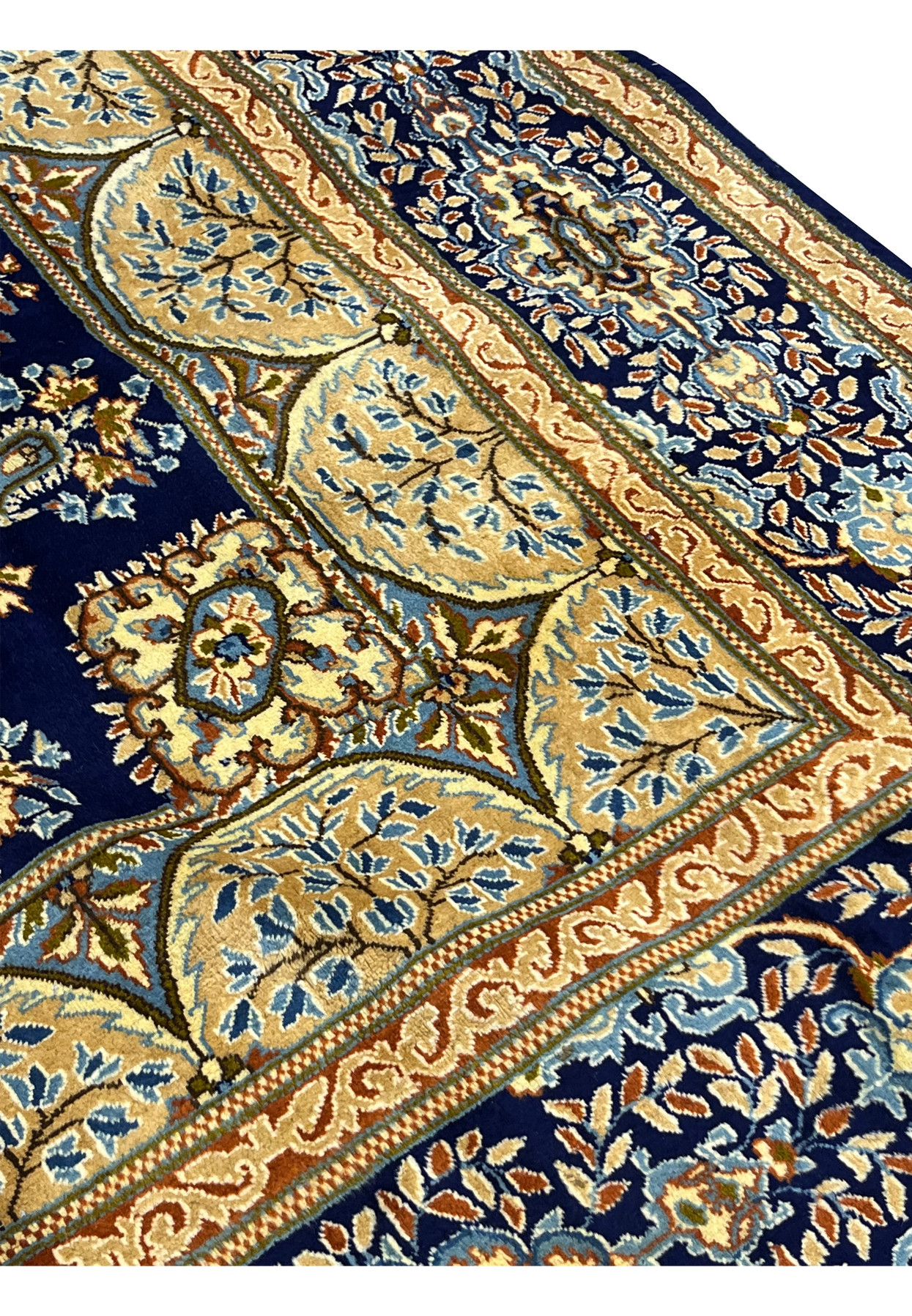 Inner border floral pattern of Persian Yazd rug showing scalloped cartouche with branch and leaf detail on sky blue