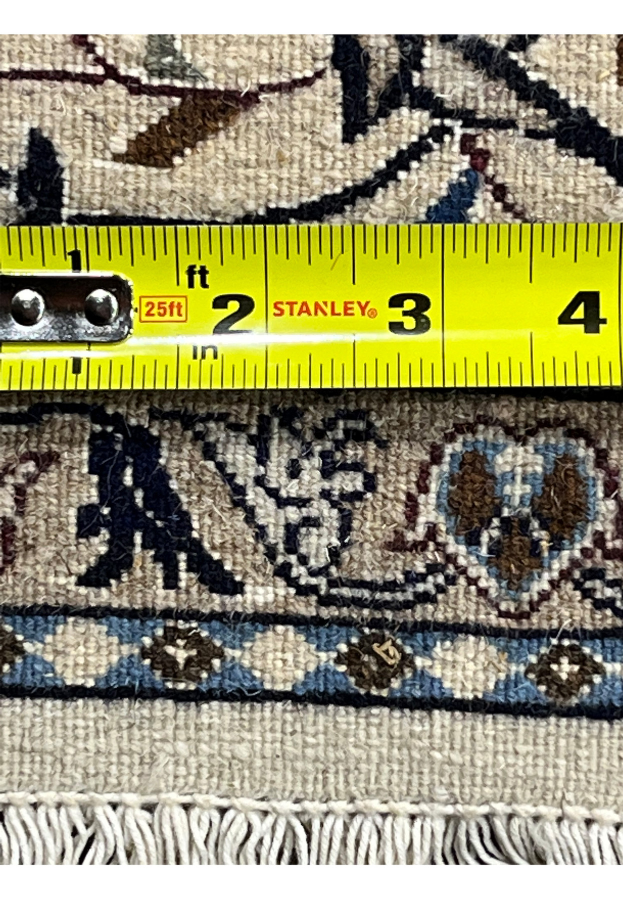 Tape measure across the back of the Nain rug confirming the fine 9 LA knot density per inch
