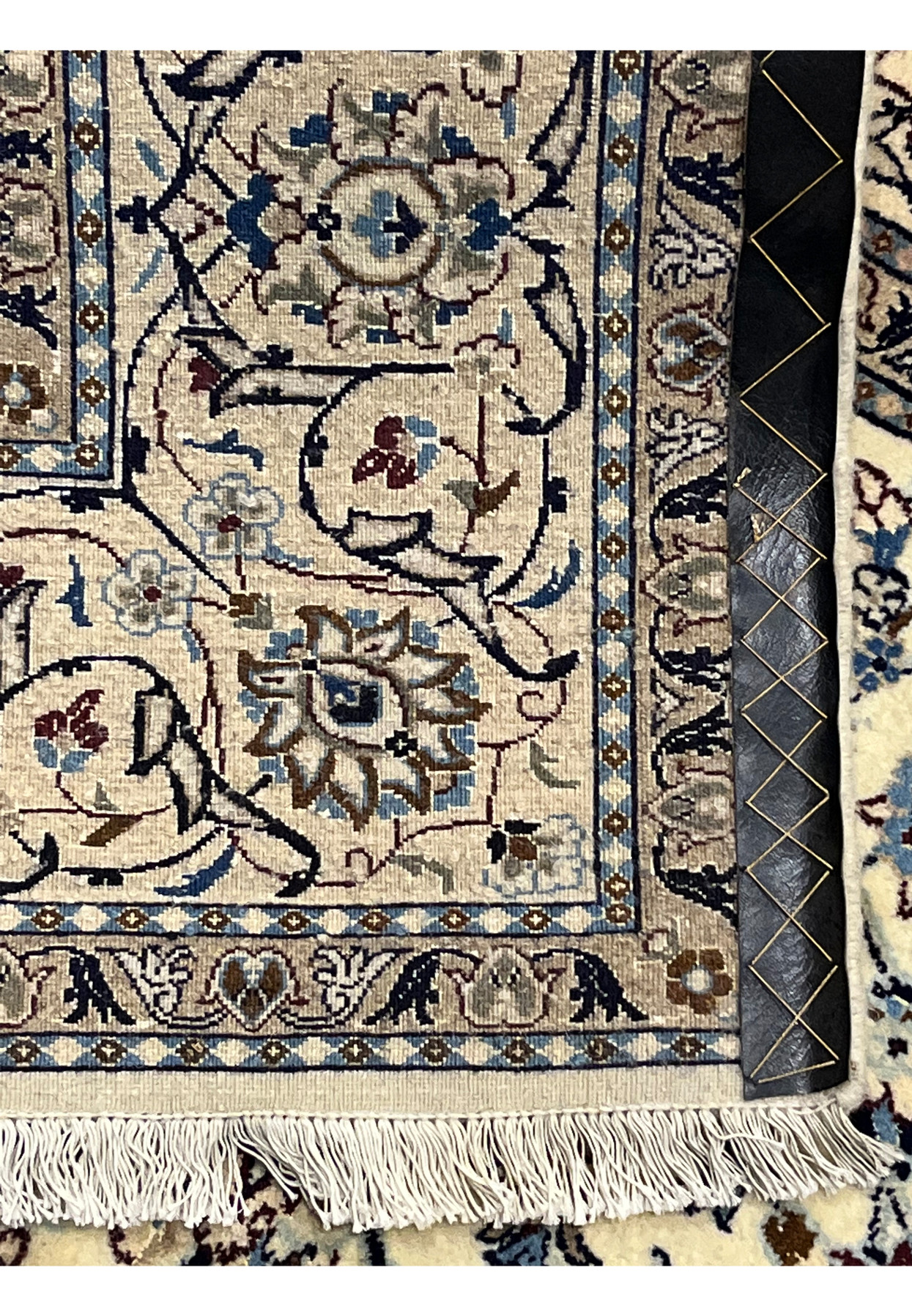 Reverse of the Nain rug showing fine hand-knotting on cotton foundation with ivory fringe