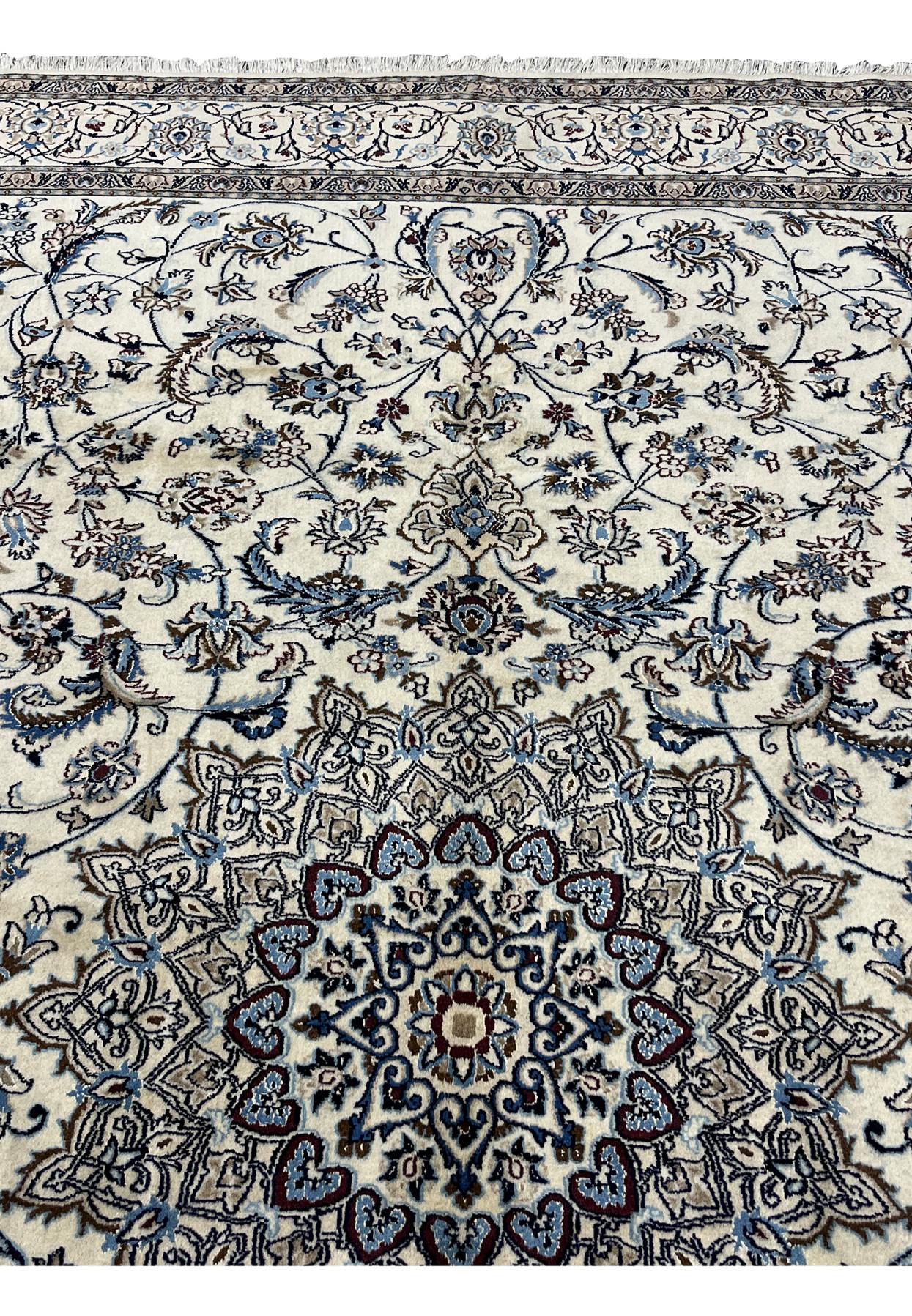 Close view of the medallion and surrounding Shah Abbasi palmettes in light blue, navy and brown