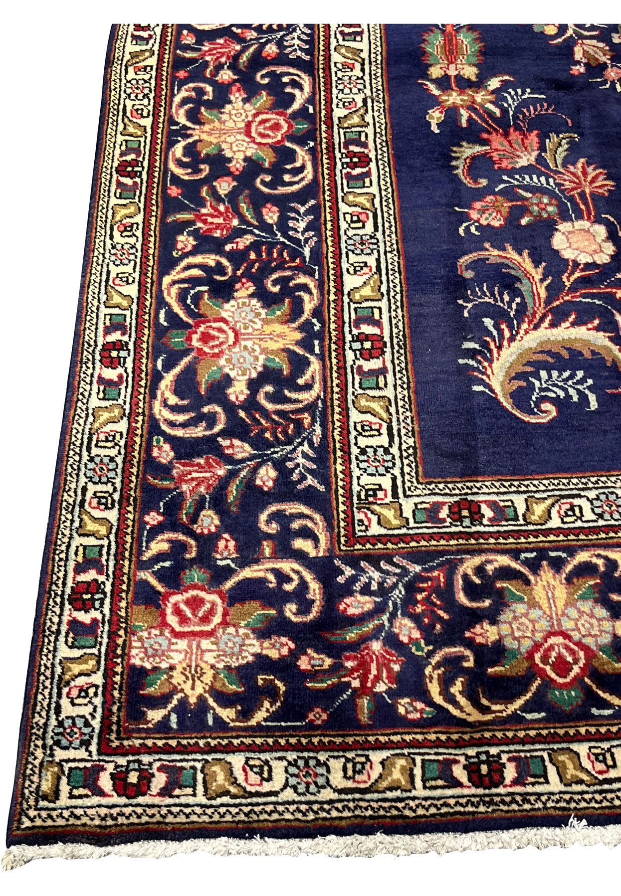 Navy main border of scrolling acanthus and rose palmettes framing a floral corner of the rug