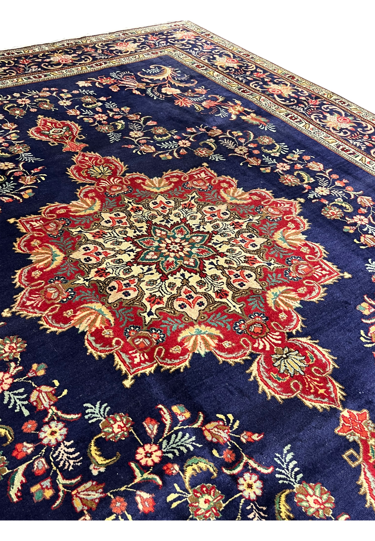 Close detail of the floral medallion with cream interior, green rosette center and serrated red surround