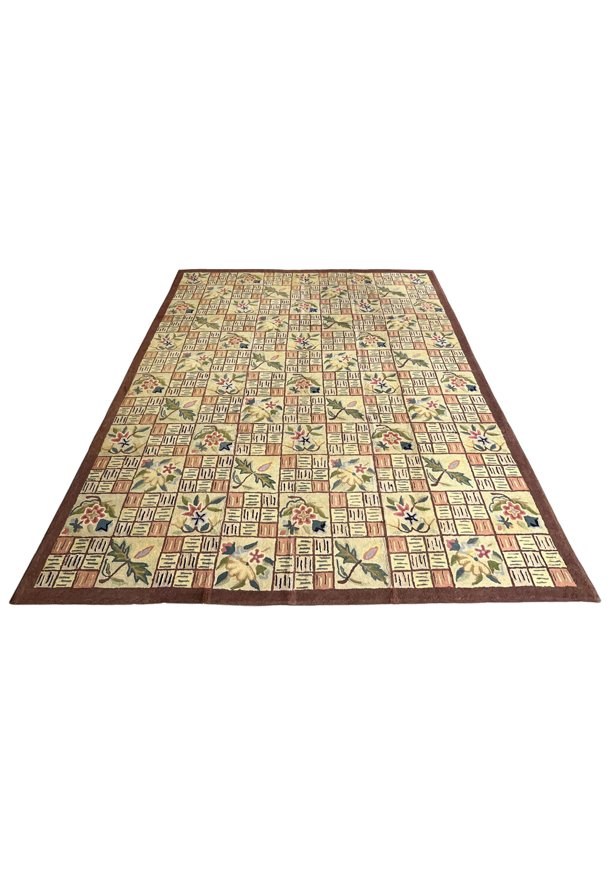 Cream and salmon patchwork hooked rug laid flat showing the full quilt block design