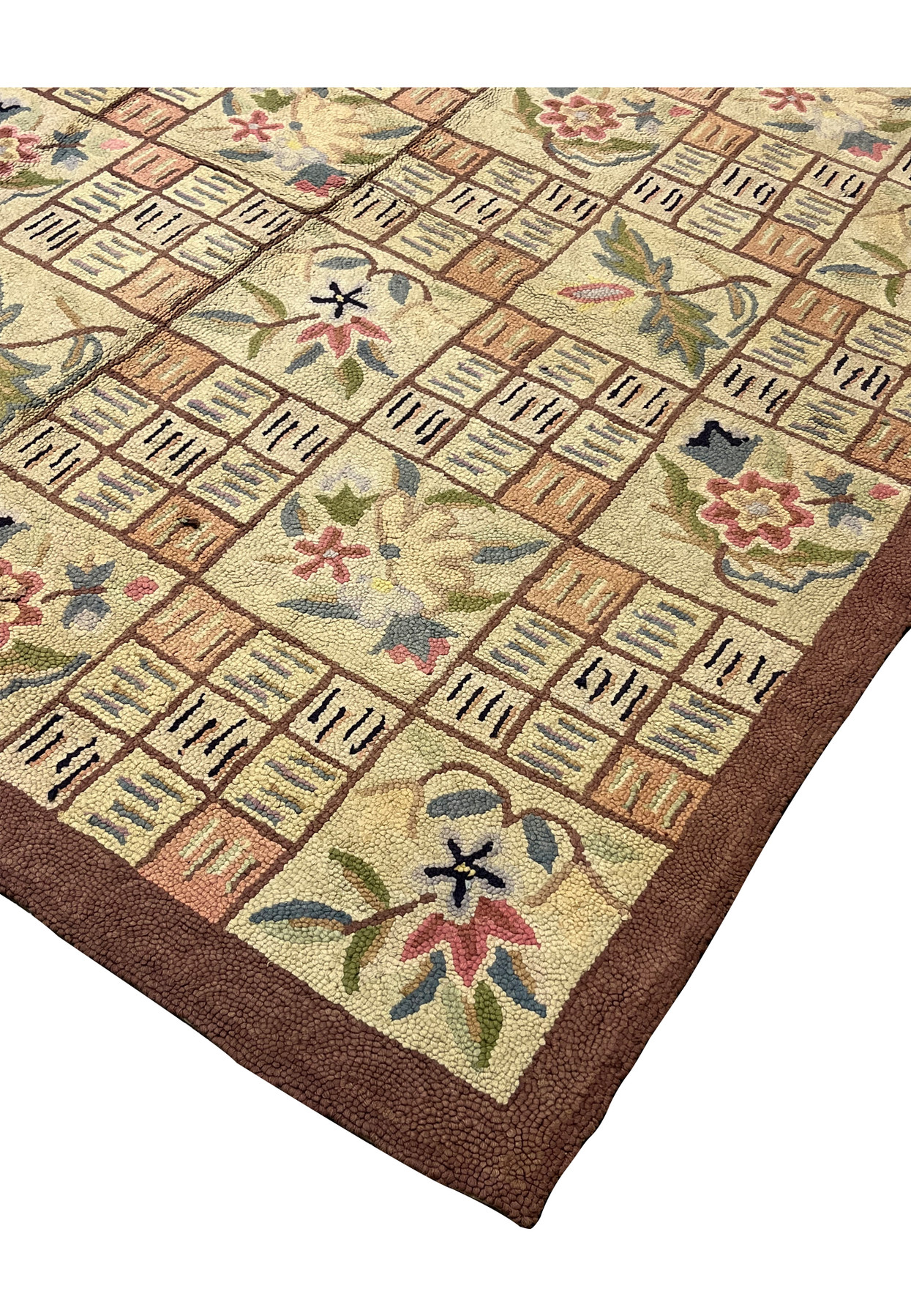 Living room ready hooked area rug corner showing dense loops and rich brown framing