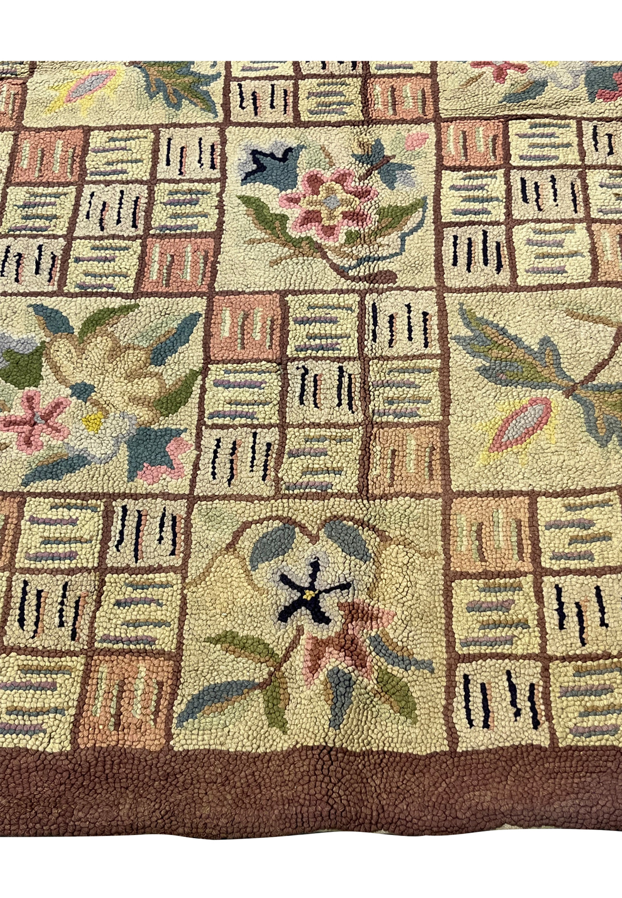 Lower edge of the 9x12 hooked Oriental rug showing the solid chocolate brown border