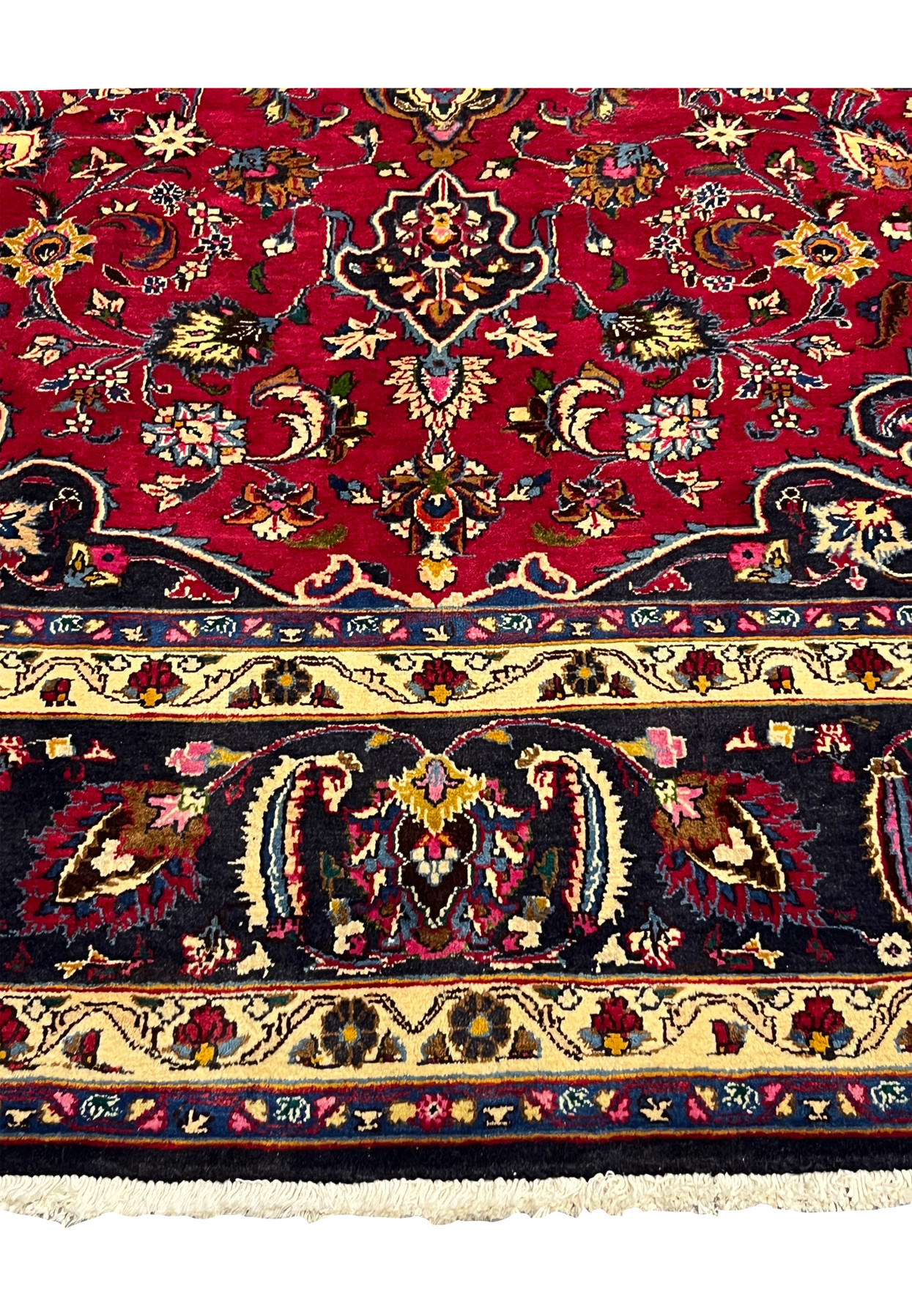 Lower border of the Mashad showing navy boteh paisleys between butter yellow guard bands