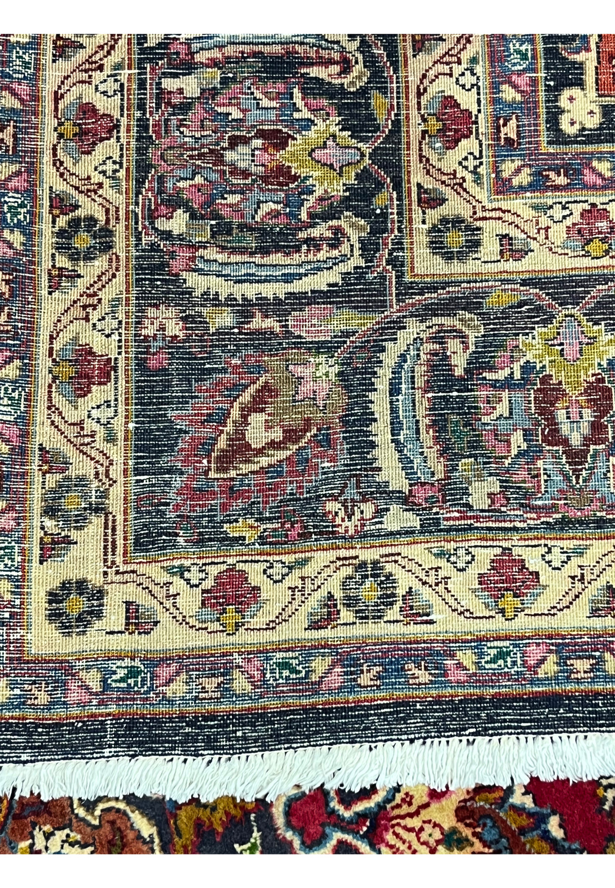 Reverse of the Persian Mashad displaying the dense even knotting across the borders