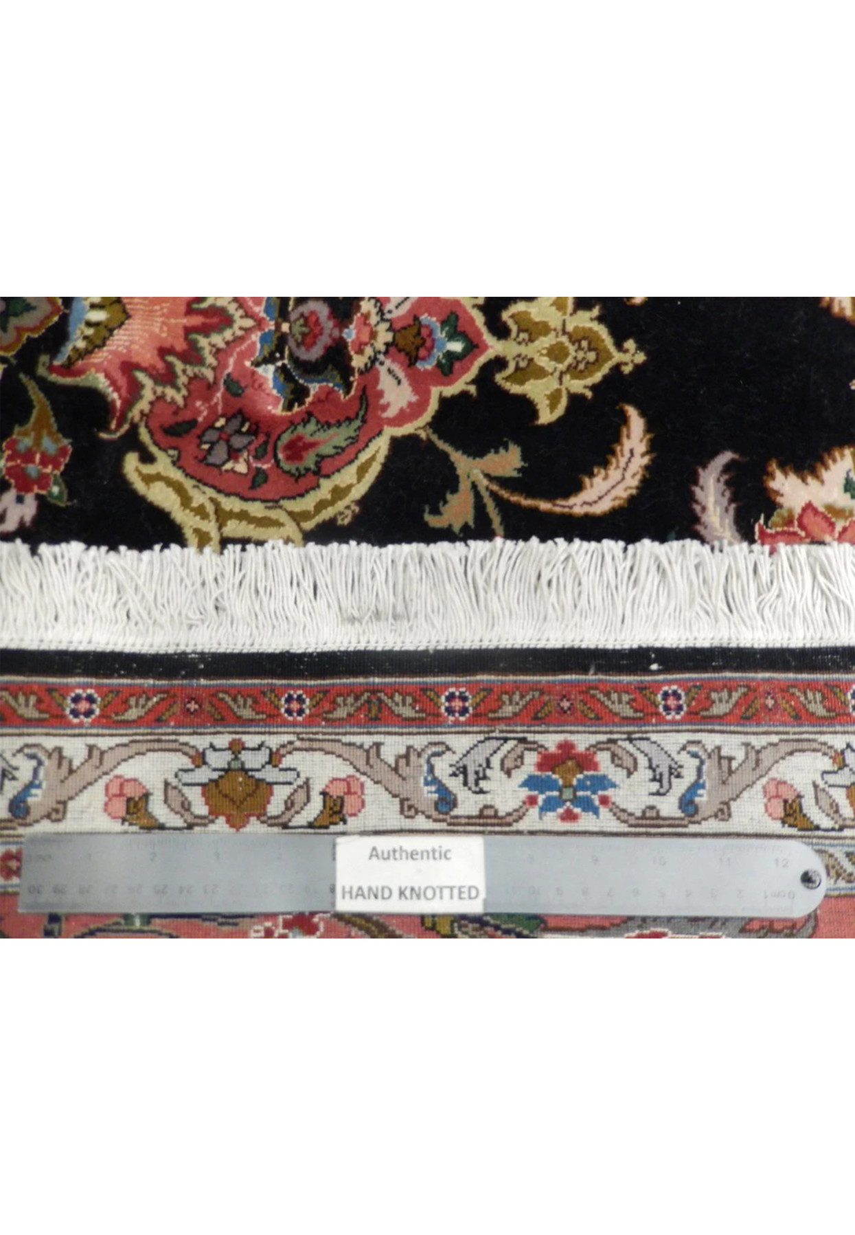 Reverse of the wool and silk Tabriz with ruler across the fine 400 KPSI knotting
