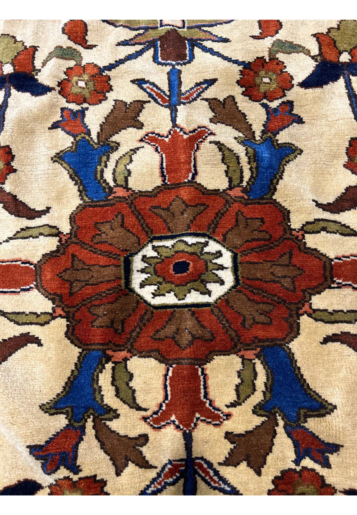 Close detail of the medallion core with rust petals and ivory floral rosette center