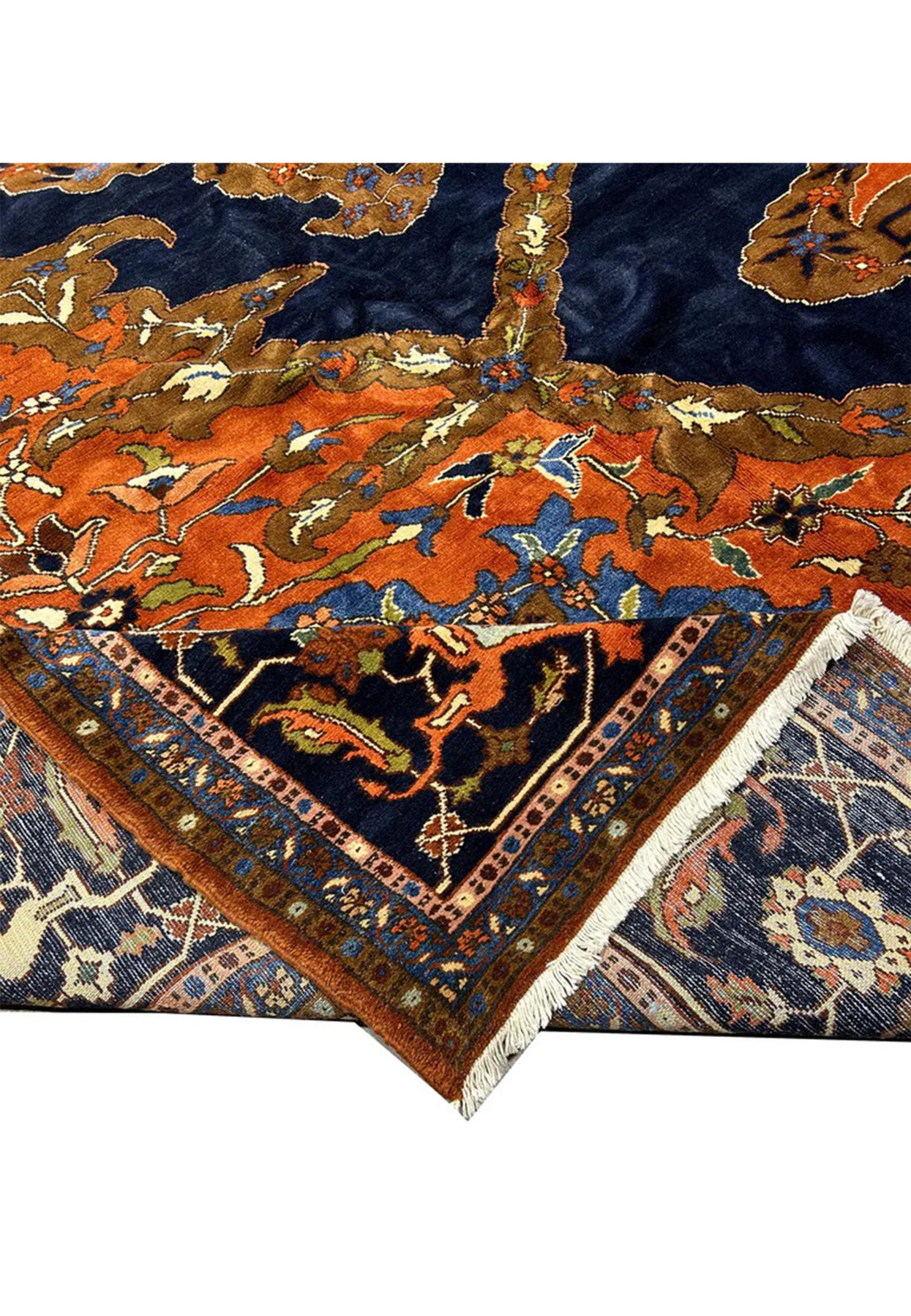 Folded corner of the navy Heriz showing border system pile depth and ivory fringe