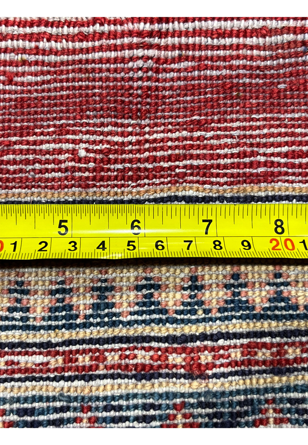 Backside with tape measure across the fine 160 to 180 KPSI hand-tied knots
