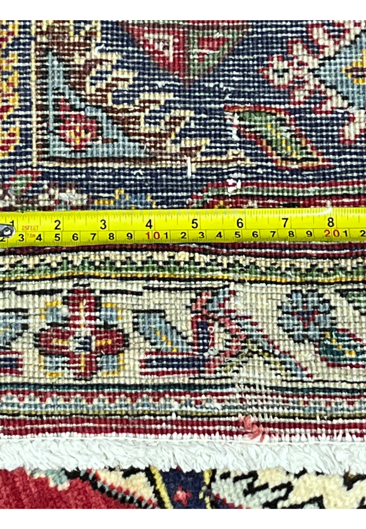 Backside knot count meassured with tape, showing 160 to 180 KPSI density on cotton foundation